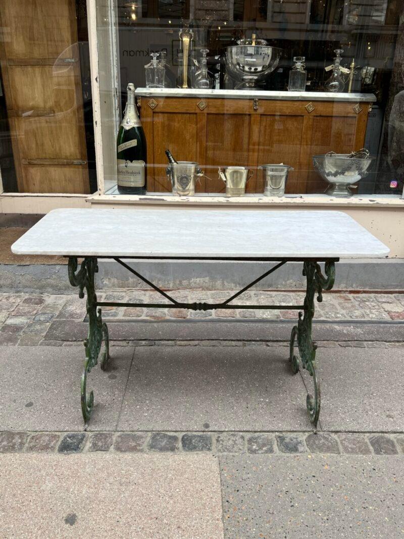 Handsome and appealing antique marble console/garden table, with an elegantly crafted cast iron base, from France early 1900s

The beautiful and solid pale marble top rests on an elaborately decorated base, painted in a delicate dusty green shade