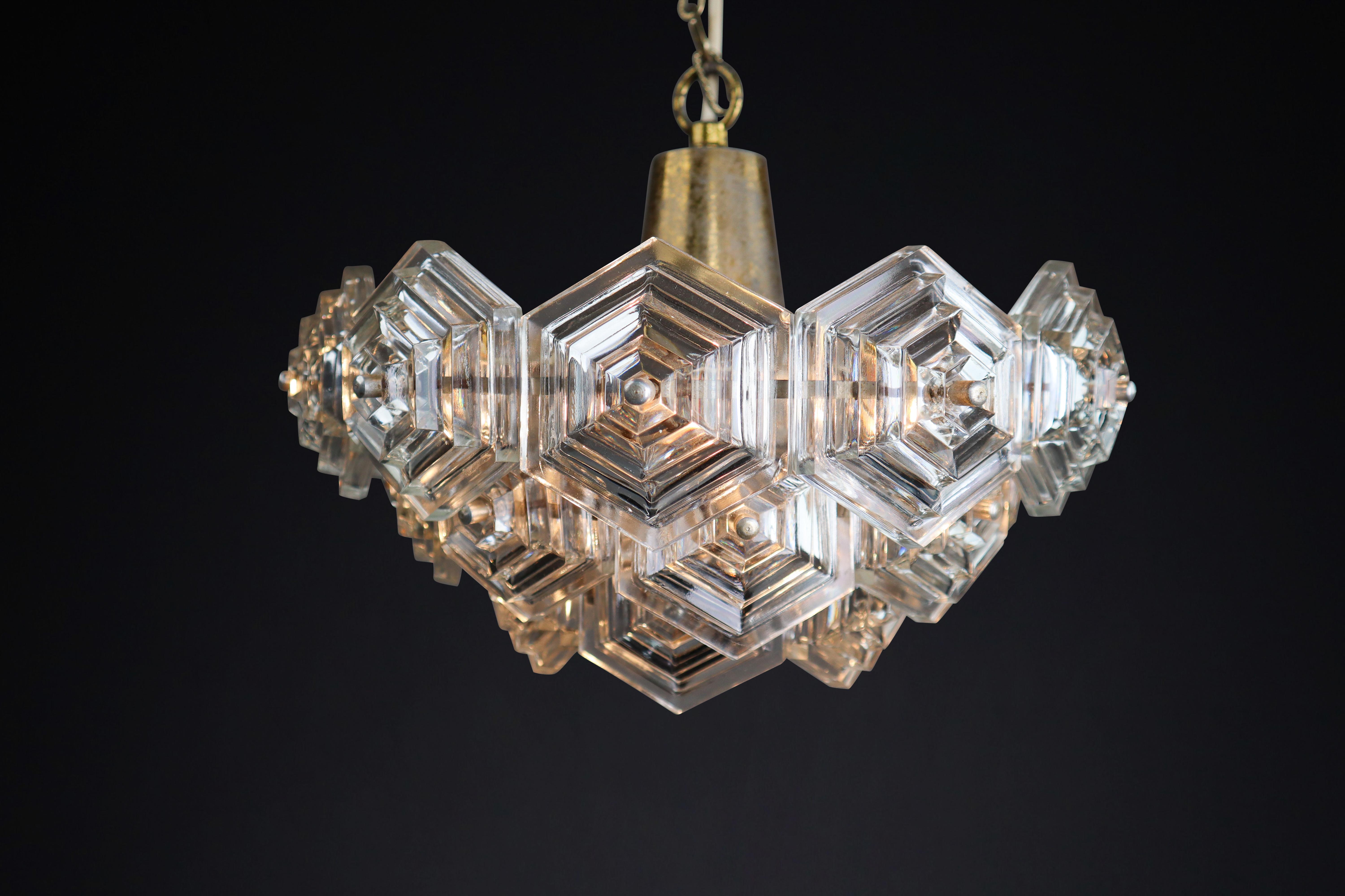 Patinated Brass and Glass Chandelier by Kamenický Šenov Czechoslovakia 1960s

This is a beautiful patinated brass chandelier from Kamenický Šenov, Czechoslovakia, in the 1960s. It is in excellent vintage condition and fully functional with porcelain
