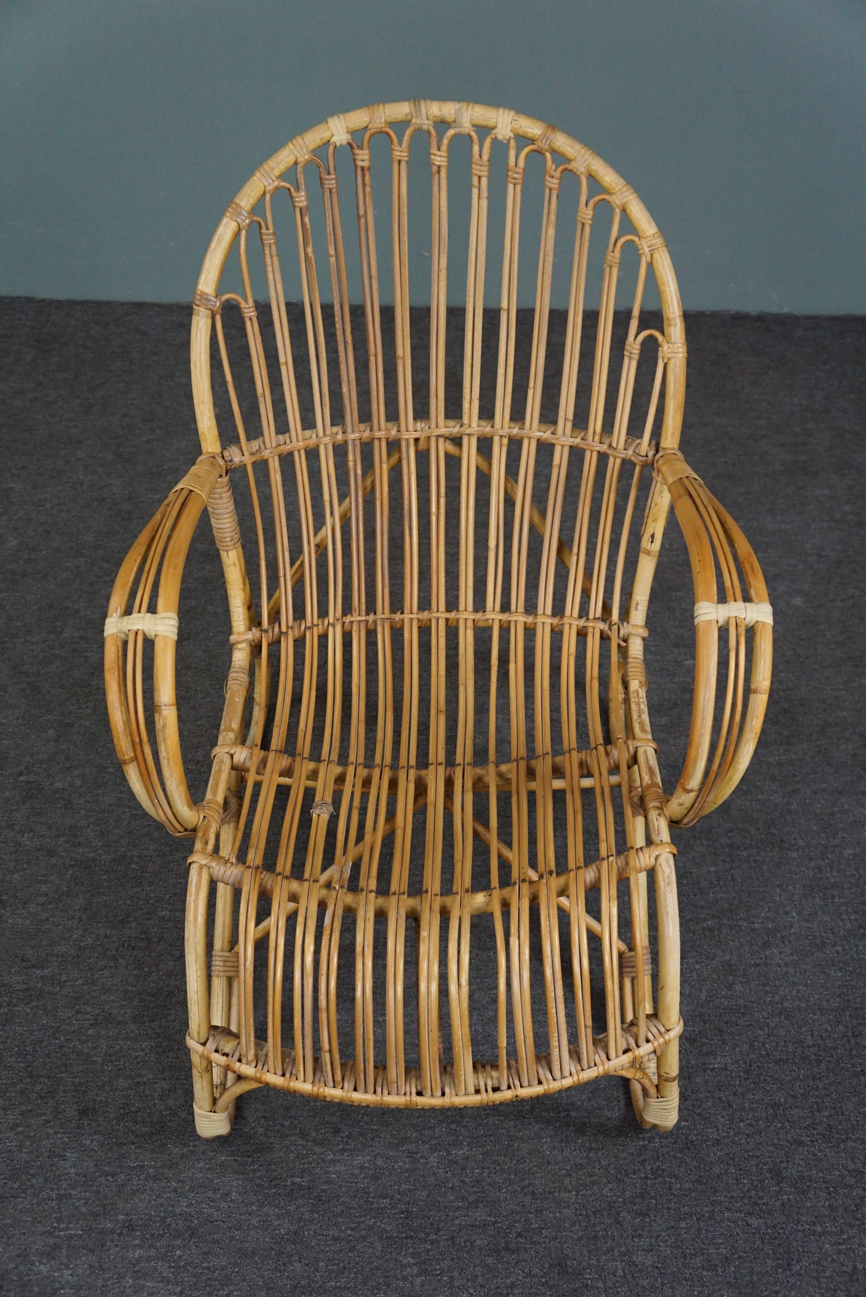 Offered is this beautiful patinated rattan armchair made in the 1950s in the Netherlands.

This sturdy aged rattan armchair has a beautiful subtle design and beautiful round details. The open character of this chair also gives a spacious effect to