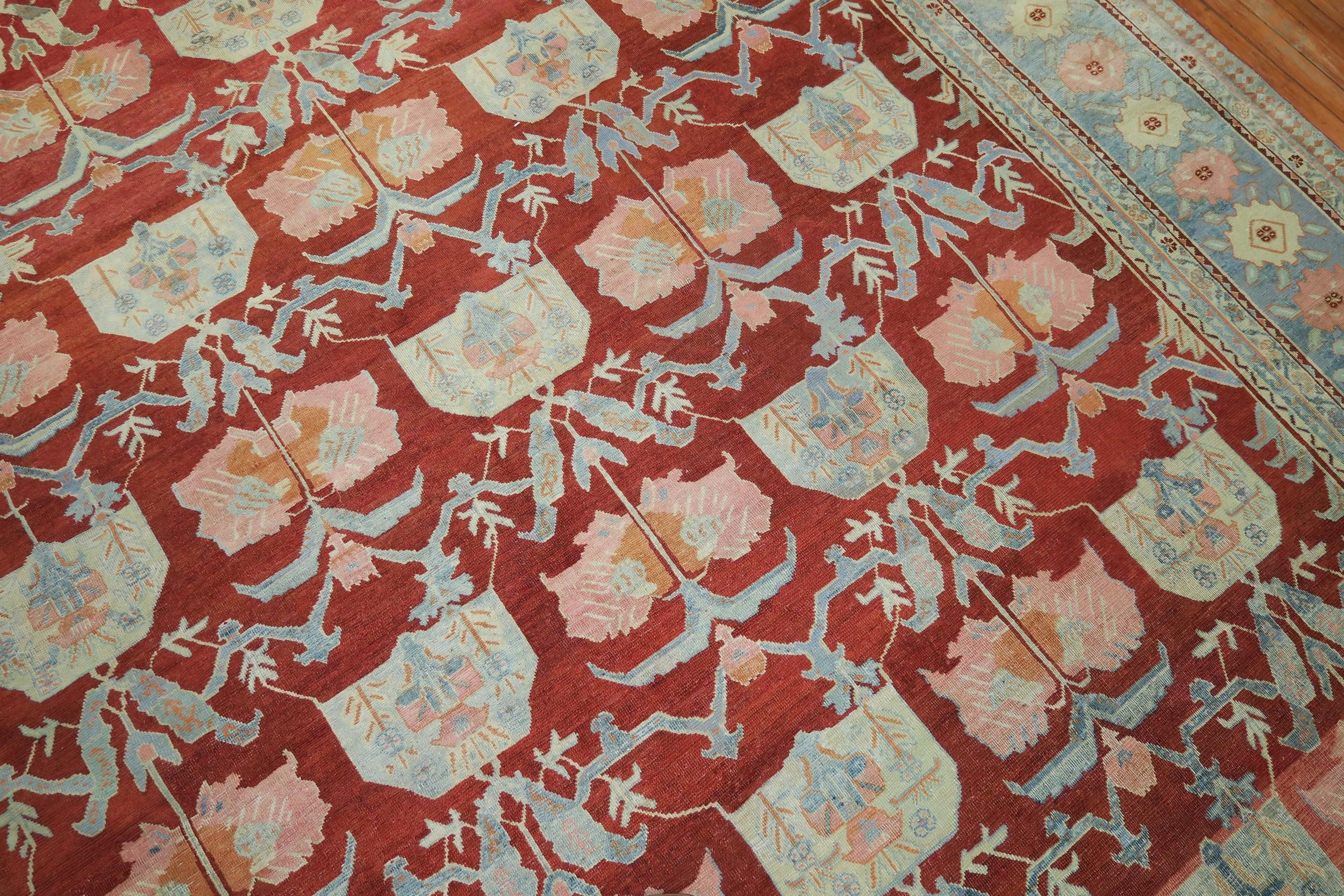 Fine quality Northwest Persian rug with a floral all-over design set on a tomato red field, accents in hot pink, gray and apricot, and a light blue border

Measures: 10'1” x 13'5”.