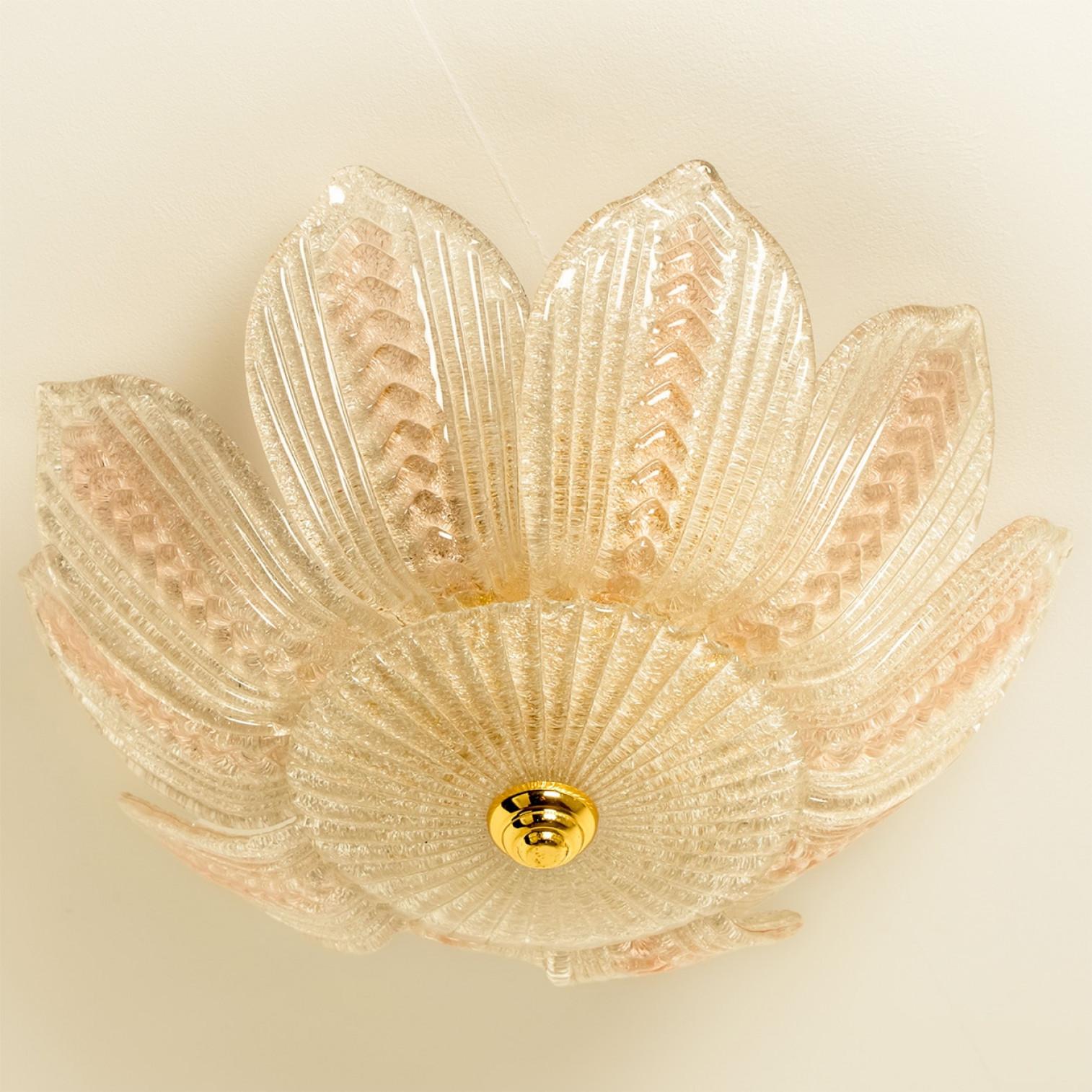Beautiful and elegant hand blown glass chandelier in the style of Barovier. Made around the 1960s.

This light fixture consists of 10 hand blown clear with pink glass leafs. Mounted on an brass frame. The leaves refract the light beautifully. This