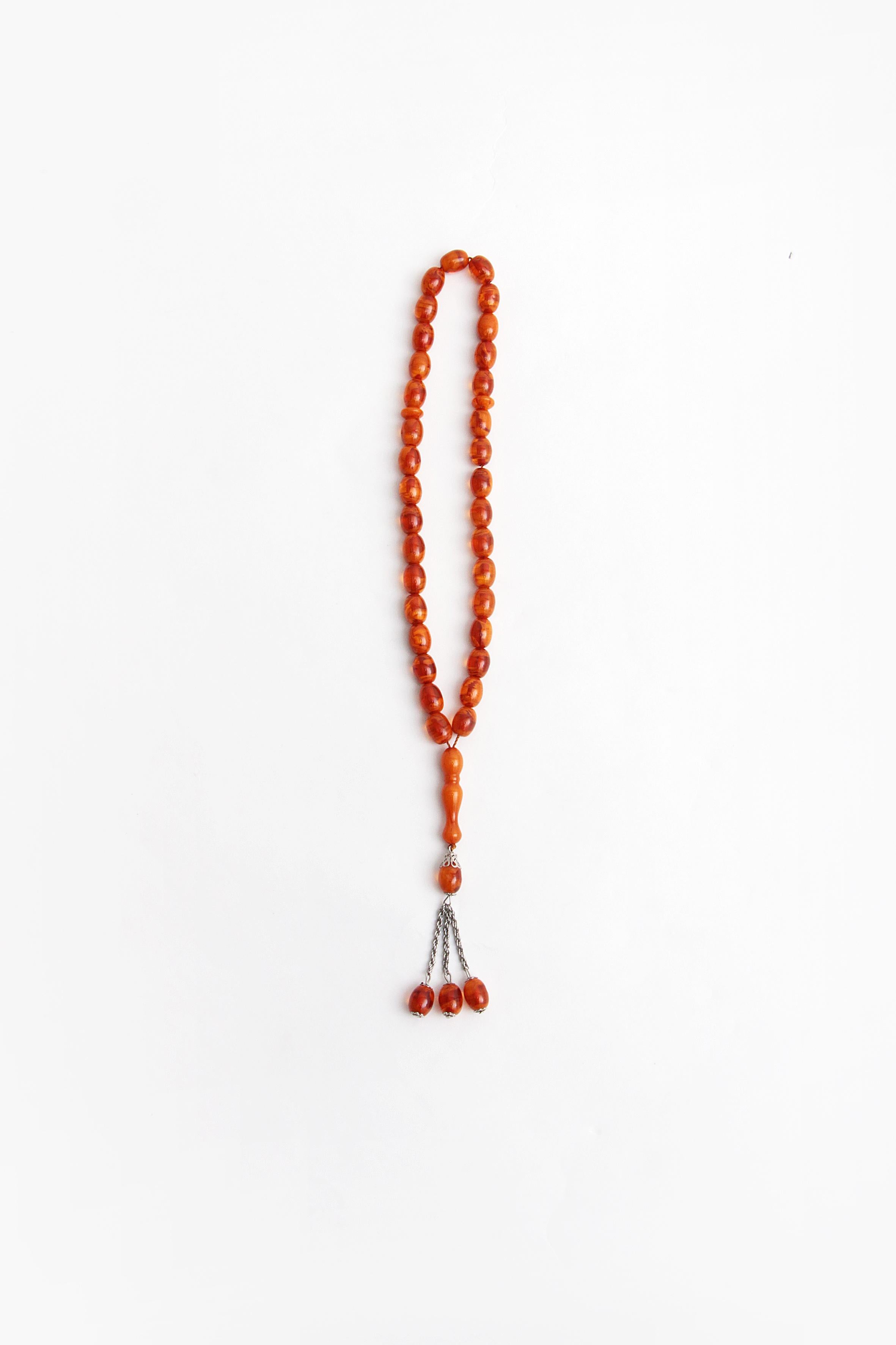 This is a beautiful amber prayer necklace nicely strung with metal details.

This is an amber necklace which is strung with regular beautiful orange red beads.

The necklace has acquired a beautiful patina over the years.

Length 33 cm, 36