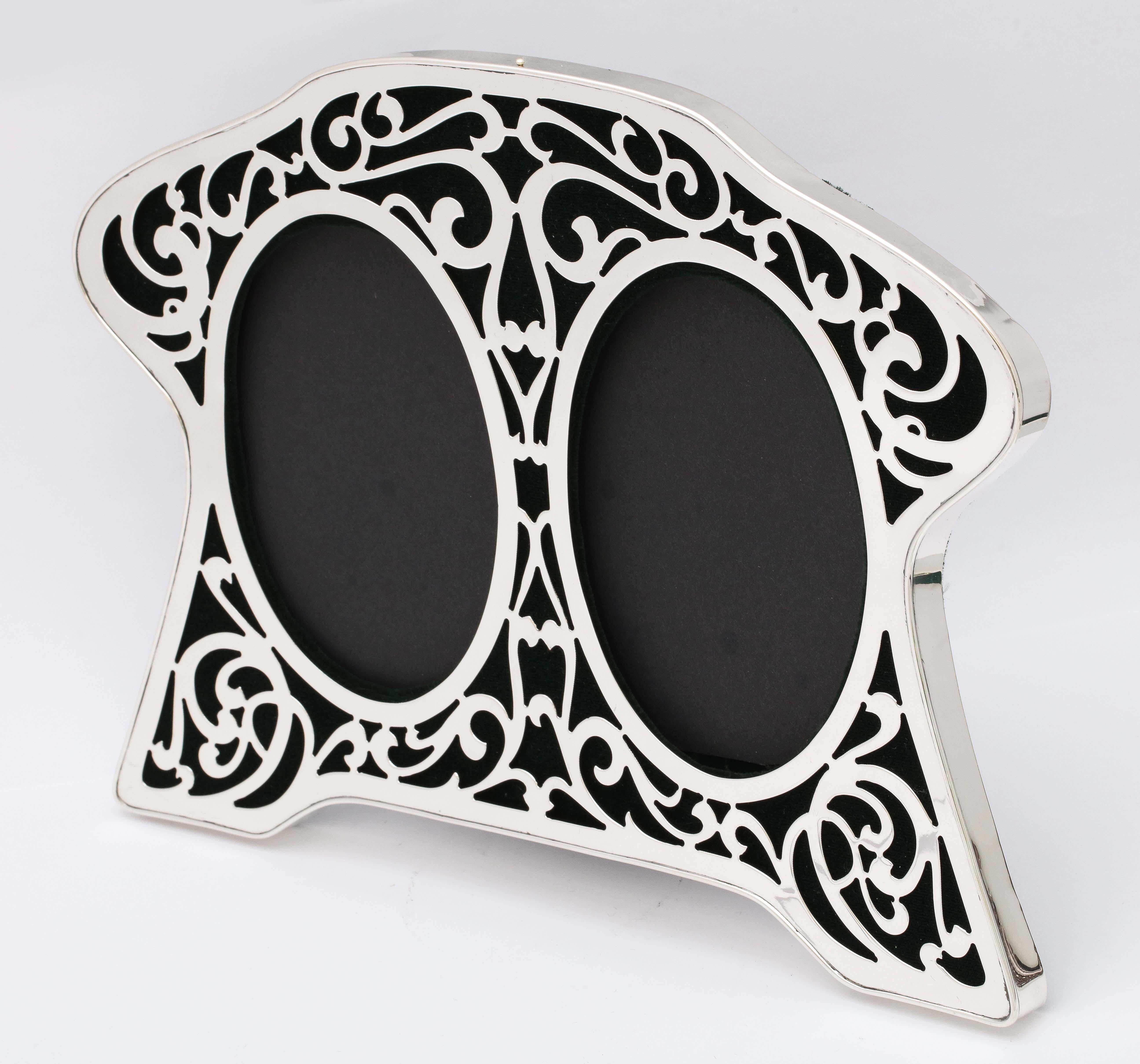 Beautiful, rare, Art Nouveau, sterling silver large double picture frame, American, circa 1900. Backed in dark green velvet. Graceful, swirled, sterling silver pierced design allows dark green velvet to show through piercing. Frame measures 8 3/4
