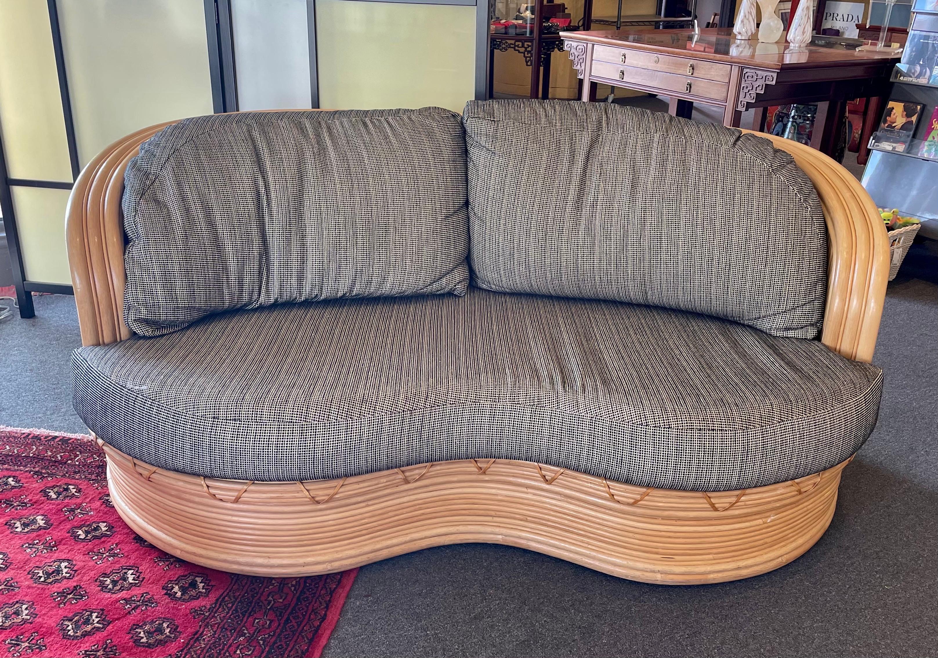 A great looking loveseat sofa pencil reed rattan freeform loveseat boho chic style, sculptural lines in Oasis sofa style great condition nicely upholstered, and good clean condition.