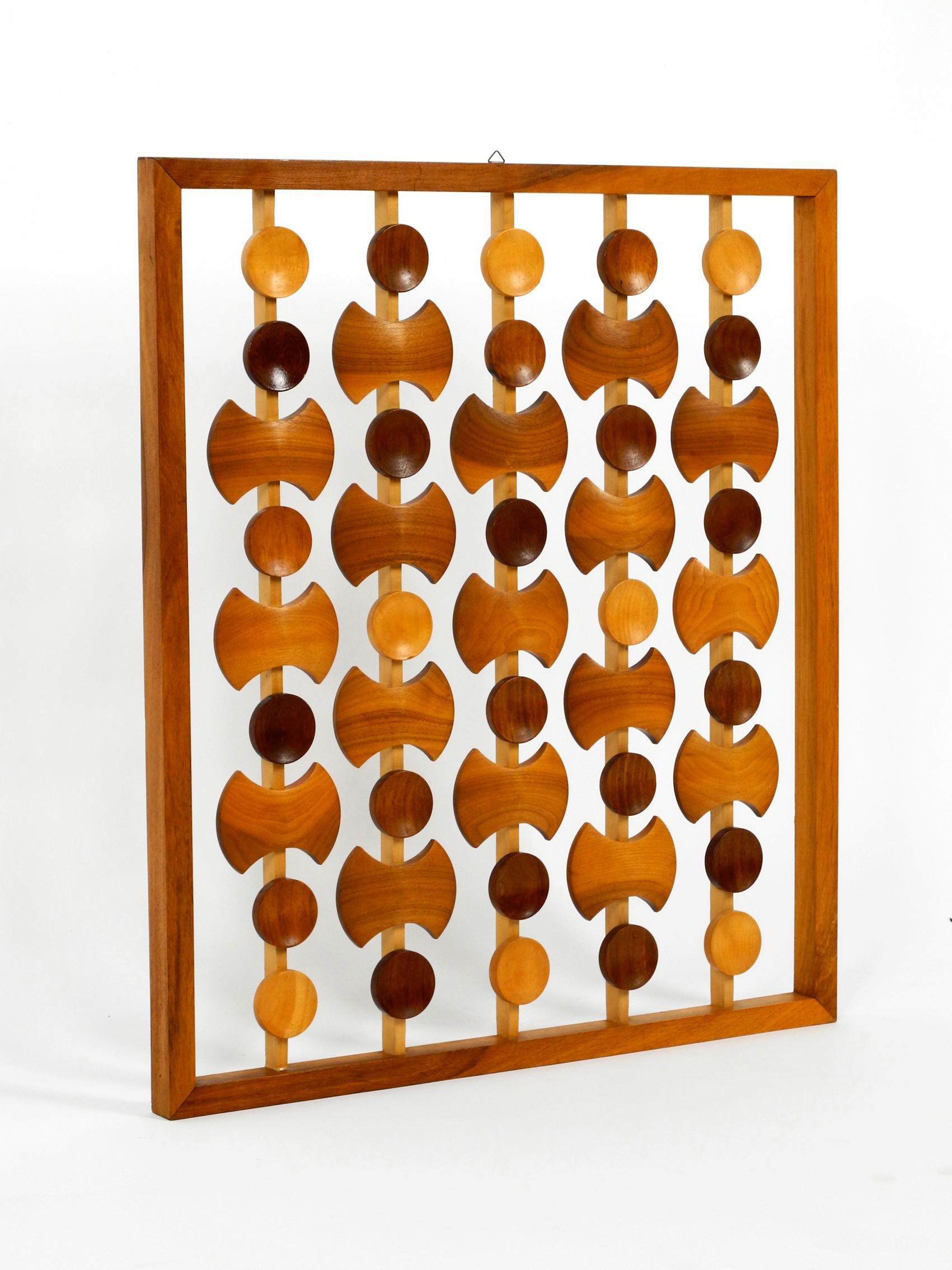 Very rare beautiful large abstract teak wall decoration. Made in Denmark.
Great Scandinavian design with a teak frame and individual elements 
of light and dark teak assembled inside. With original hooks for the wall mounting.
Very good vintage