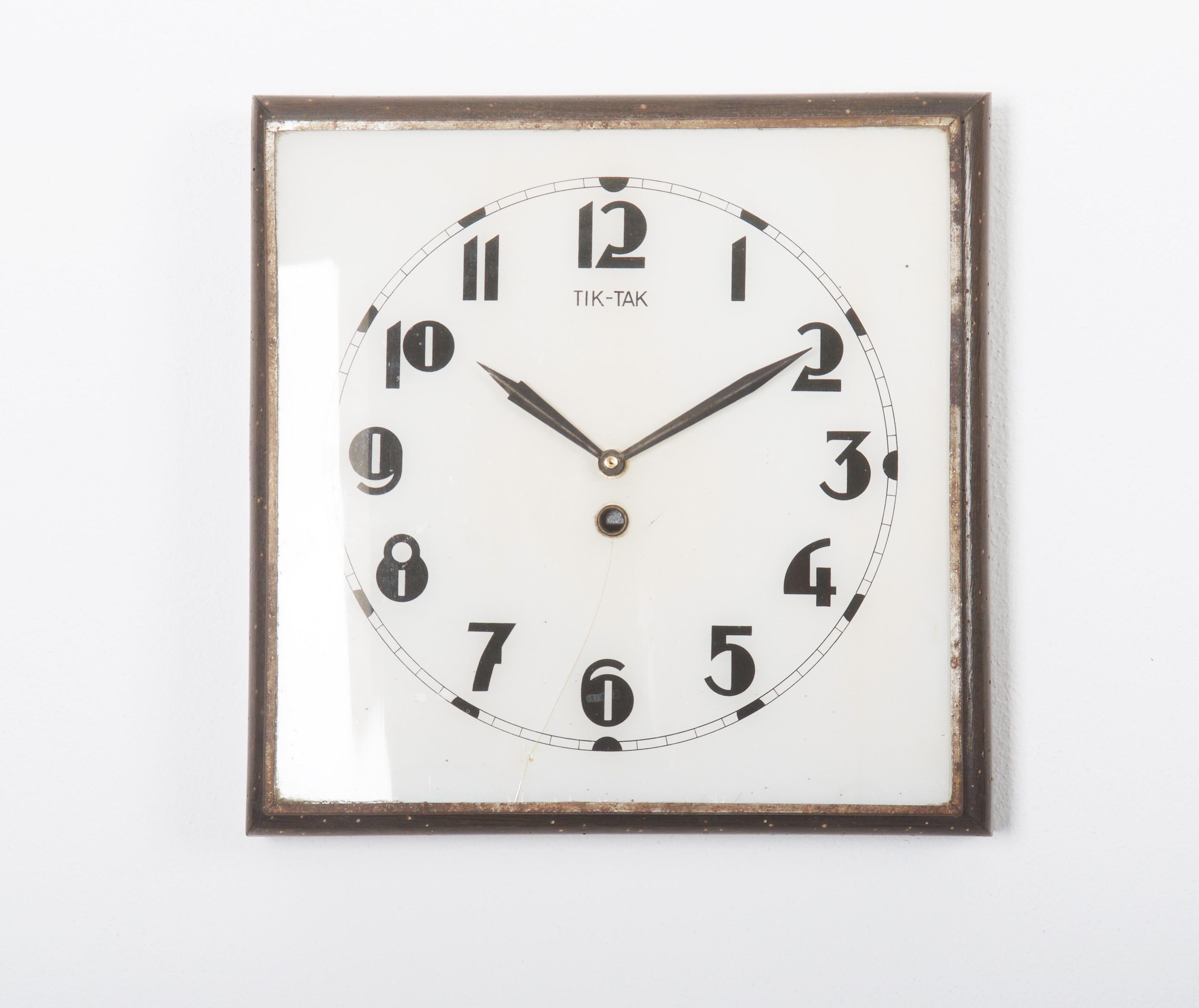 Wooden frame with white glass and black digits caught in steel, the glass clock face is partially broken see the pictures. Made by Prim in the 1930s. The original movement ware changed to an electric one powered by a small battery.