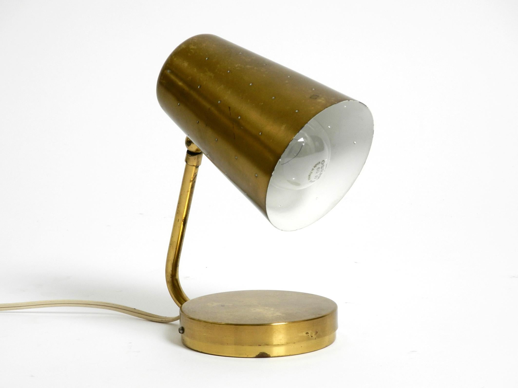 Beautiful large  Mid Century Modern brass table lamp.
The screen is infinitely adjustable. Very elegant 1950s design.
The lampshade has small holes, with the light shining through it looks great.
In very good vintage condition. No damage, no dents