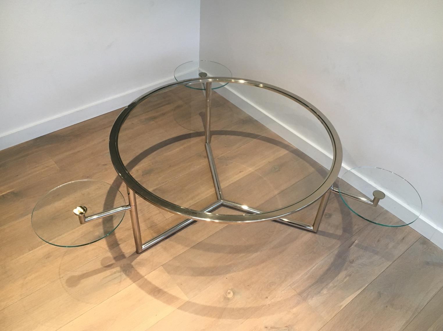This beautiful and rare round coffee table is made of chrome with clear glass shelves. This is an interesting round model with 3 removable round glass shelves that can be adjusted to the use of the table. This is a French work, circa 1970.