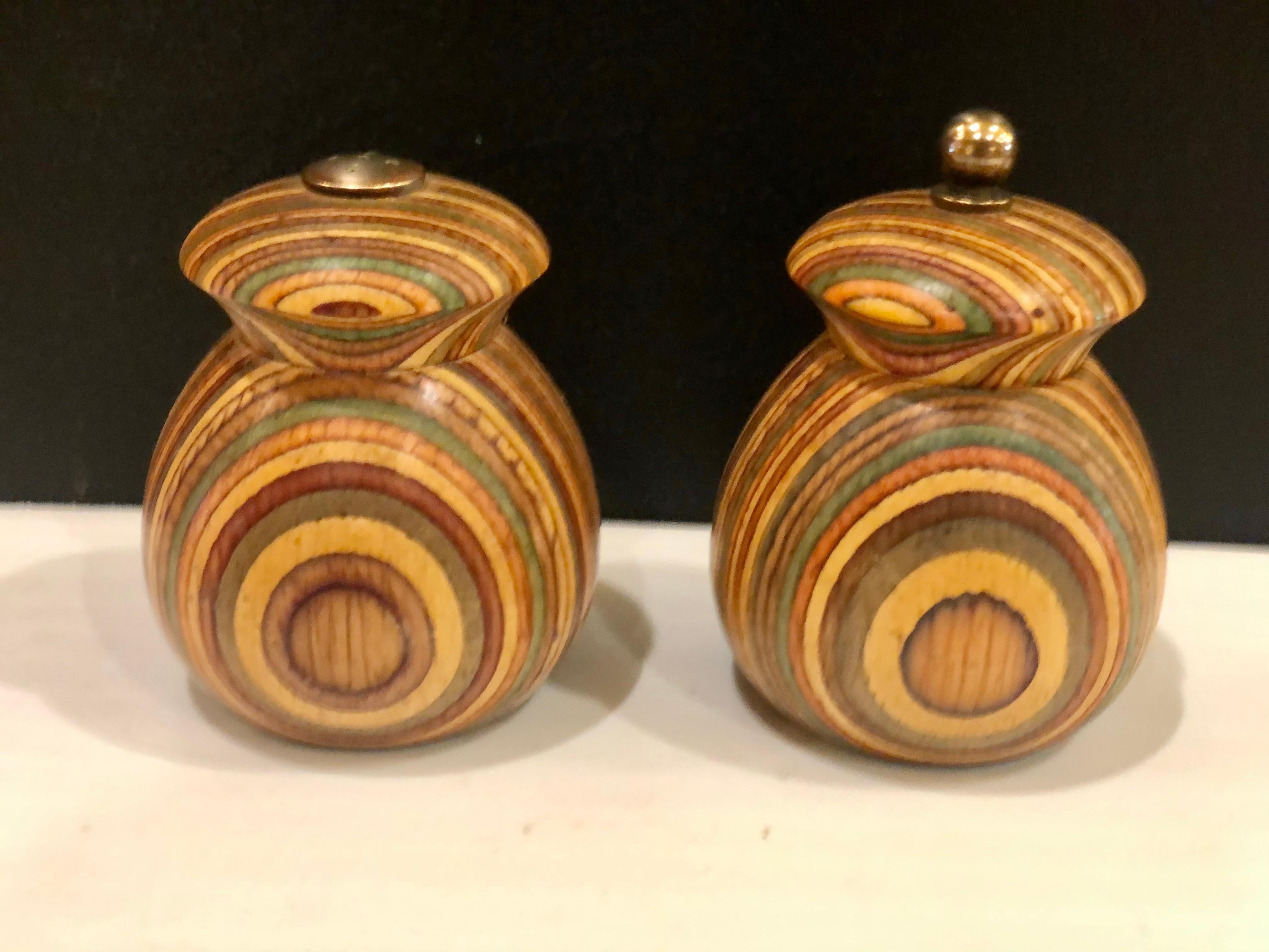 Nice and rare pair of salt and pepper shakers circa 1980s solid zebra wood with brass fittings we polished the brass they are in nice working condition.