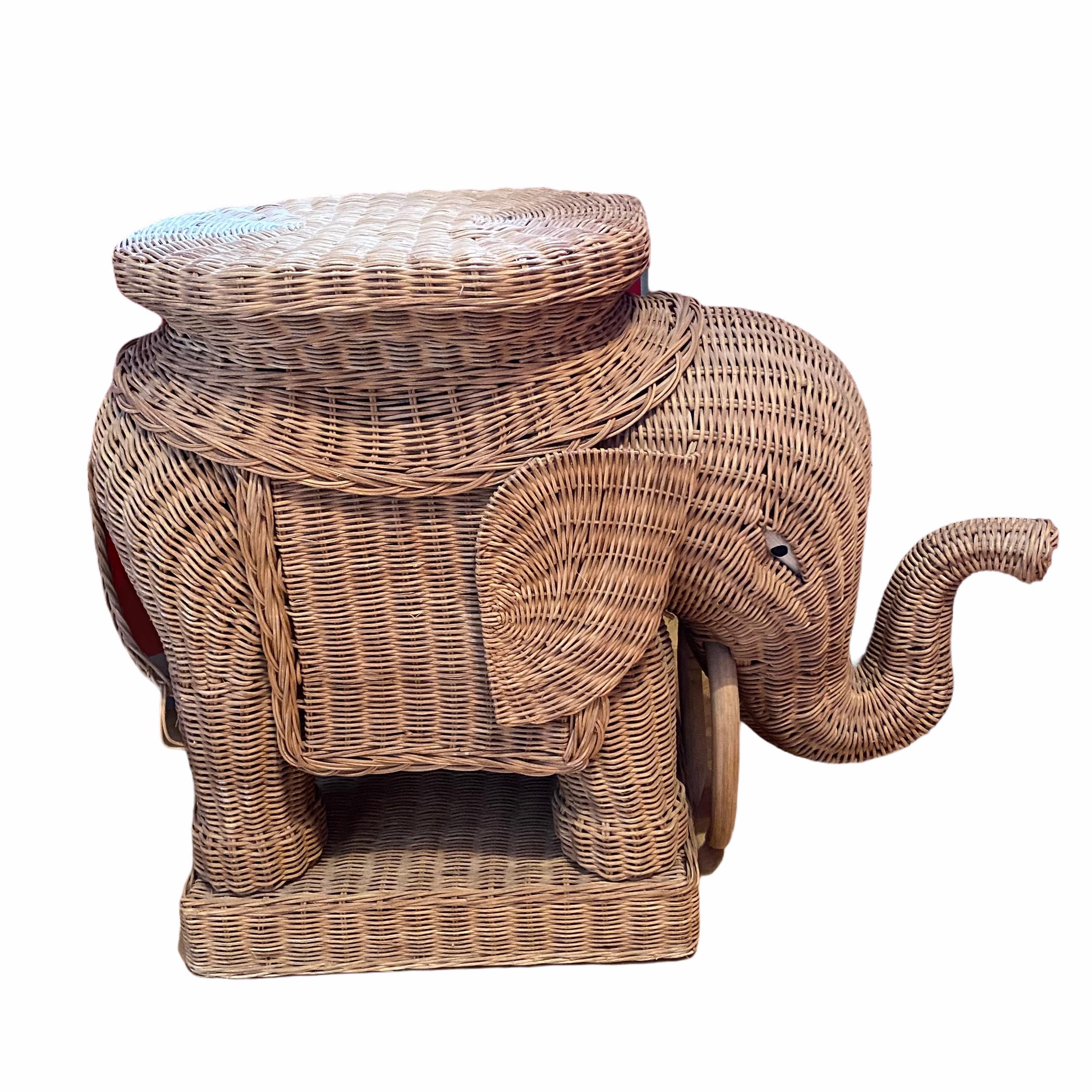 Mid-20th century eye-catching elephant-shaped end table or side table, constructed in hand-braided rattan accented with wood tusks. Nice addition to your home, patio or garden. This is in used condition, with signs of wear as expected with age and