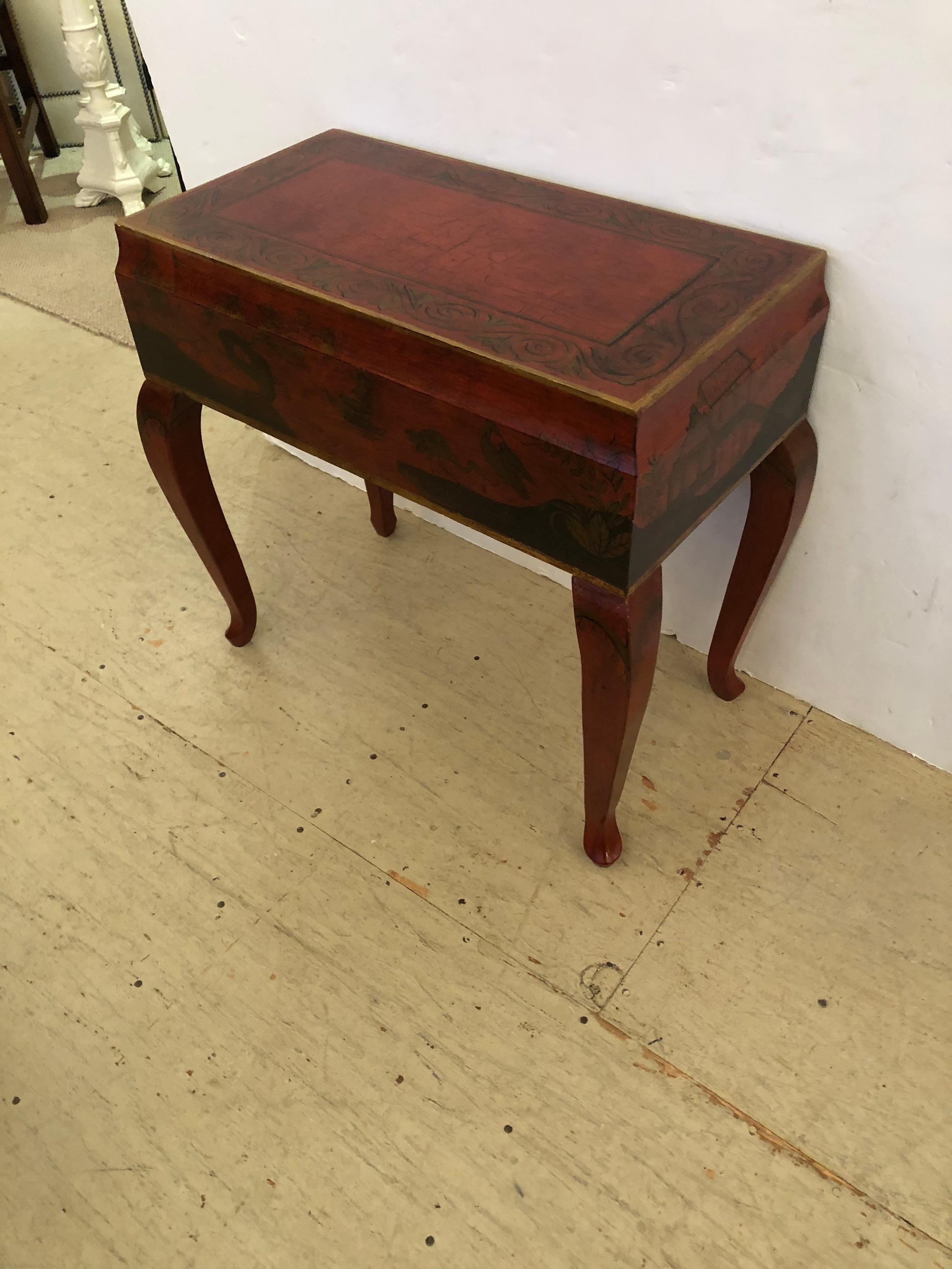 Beautiful red, black and gold rectangular end table having crackle finish top and gorgeous chinoiserie painted decoration. The exaggerated cabriole legs add a nice stylish touch.