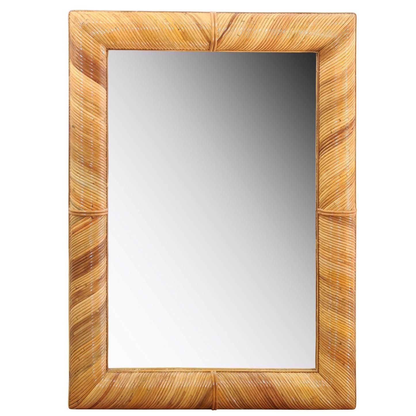 A fabulous pair of organic mirrors, circa 1980. Stout hardwood frame painstakingly veneered in diagonally applied reed bamboo. Exceptional craftsmanship. Exquisite jewelry! Excellent restored condition. The pieces have been professionally cleaned