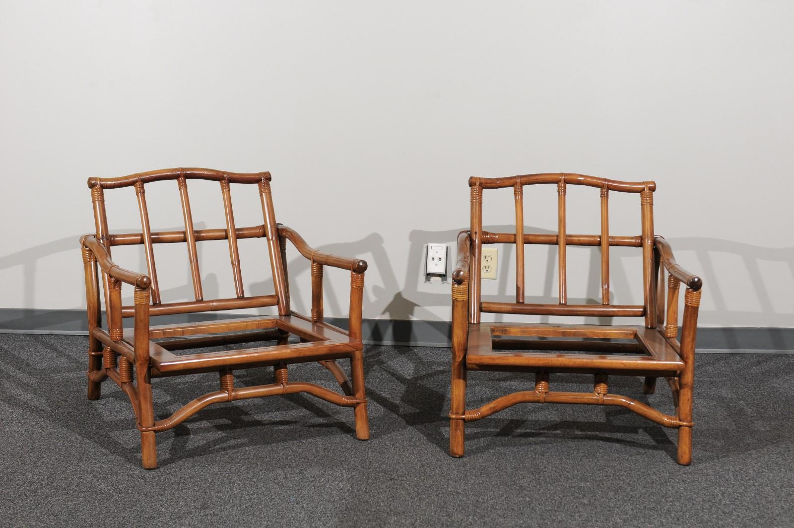 A lovely restored pair of lounge chairs from a low production series by Ficks Reed, circa 1970. Beautifully designed and expertly constructed rattan and hardwood frame with a striking Pagoda detail atop the back. Stout and comfortable. The pieces