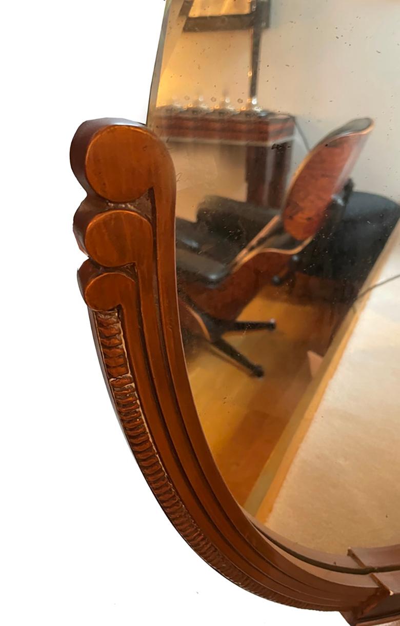 Round Art Deco mirror
A round Art Deco mirror from France, circa 1930, may be carved from wood, with decorative details and clear, geometric shaping. The frame is adorned with geometric patterns. The mirror itself is of high quality and has an