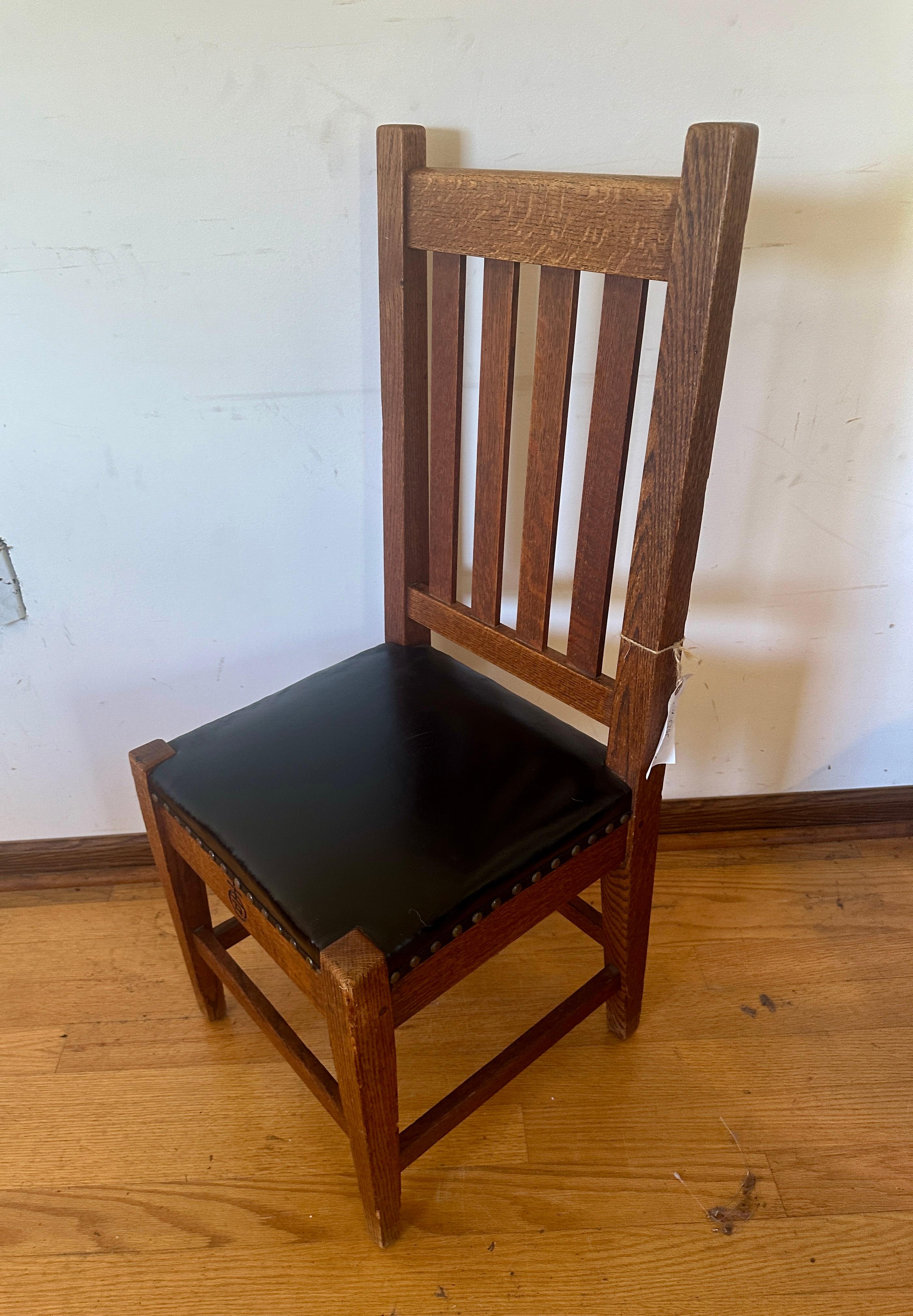 This is an antique Roycroft side chair made circa 1910 (in the Stickley era).  This high back chair is in superb condition. Made from oak and has the original finish. The chair is pinned all around.  Everything is complete with no repairs or