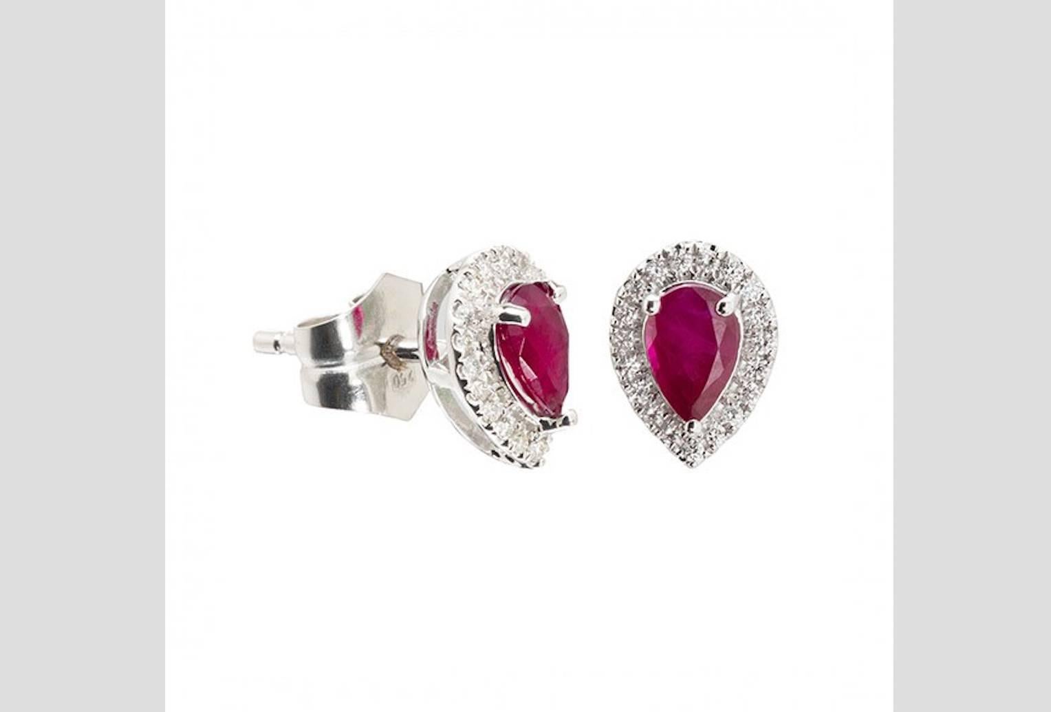 Amazing Stud Earrings set in 18 K White Gold  surrounded by wonderful brilliants and in the middle the ruby. The earrings radiate luxury and grace.

white Brilliants (a total of  0.14 ct.)
2 Rubies (a total of 1 Karat)
18 K White Gold 

Original