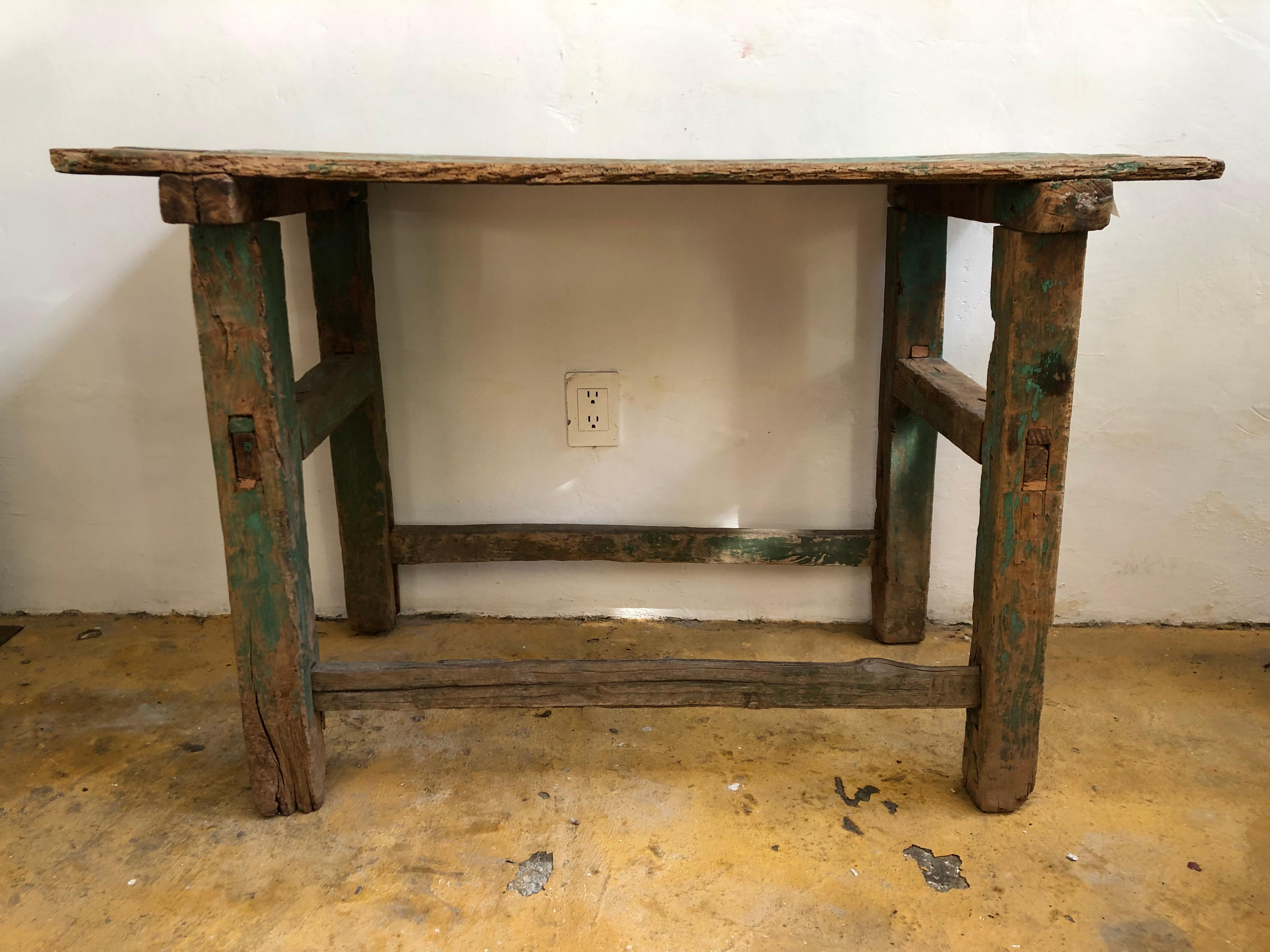 This beautiful sabino wood table was found in Zacatecas, Mexico.
It’s perfect for a side table, the rests of bright green paint and the texture of the hand carved structure, gives this table an amazing patina.