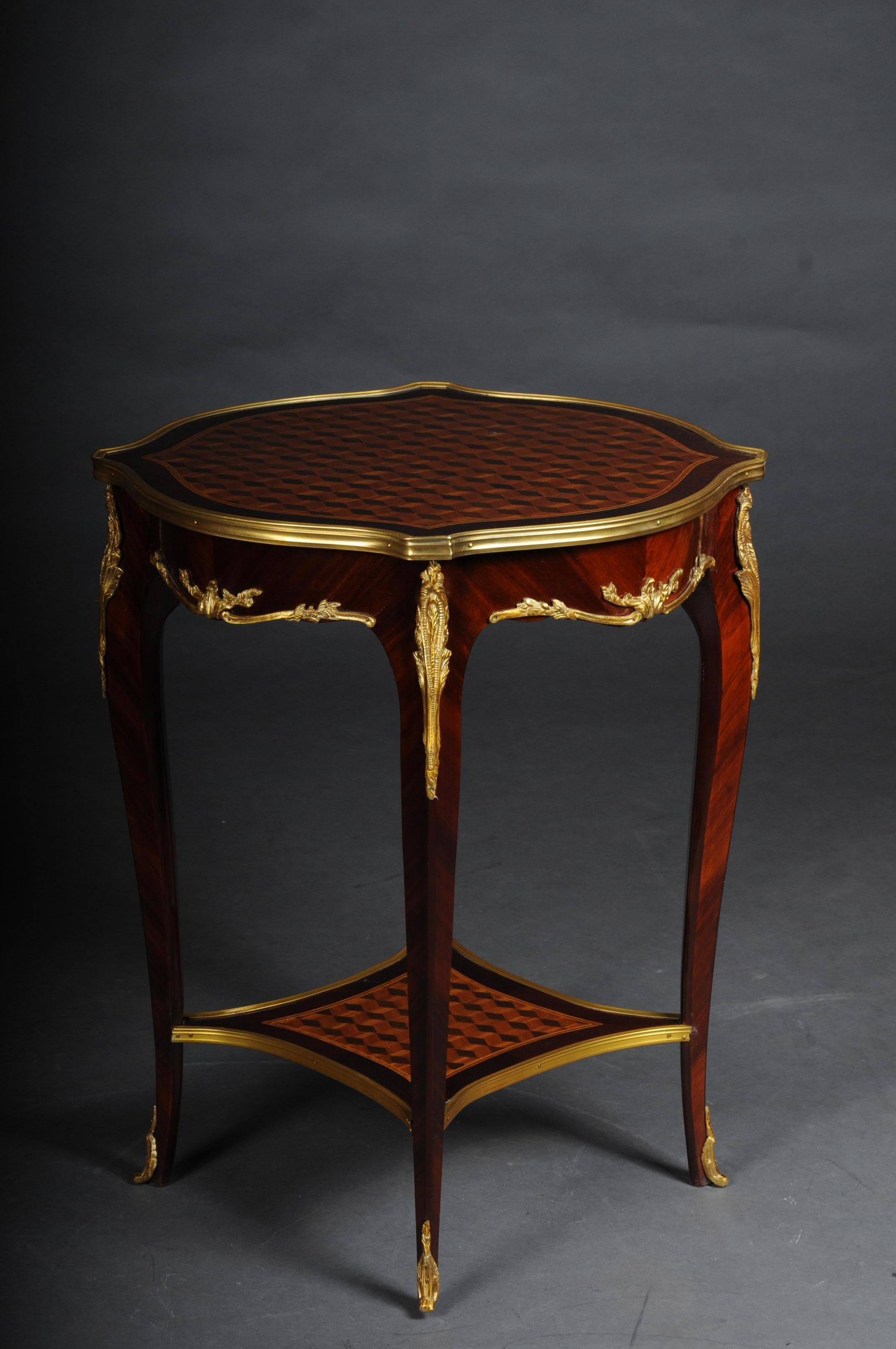 Beautiful salon side table in Louis XV after F. Linke

Veneer on solid beech, daintily finished, body, flanked by solid corner strips on high, elegantly curved legs with bronze fittings ending in sabots. Slightly protruding, round marble top plate