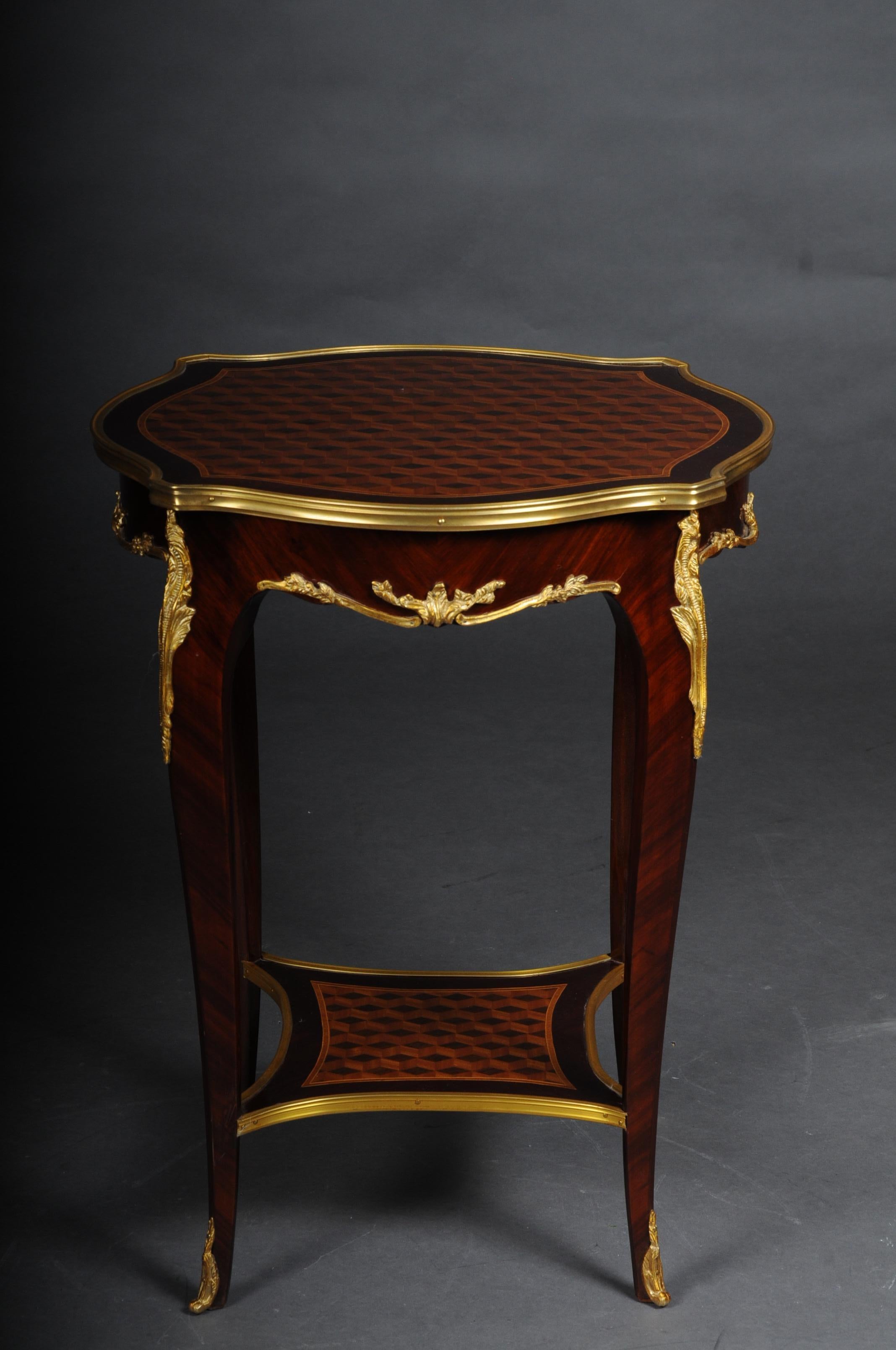 Beautiful salon side table in Louis XV after F. Linke

Veneer on solid beech, daintily finished, body, flanked by solid corner strips on high, elegantly curved legs with bronze fittings ending in sabots. Slightly protruding, round marble top plate