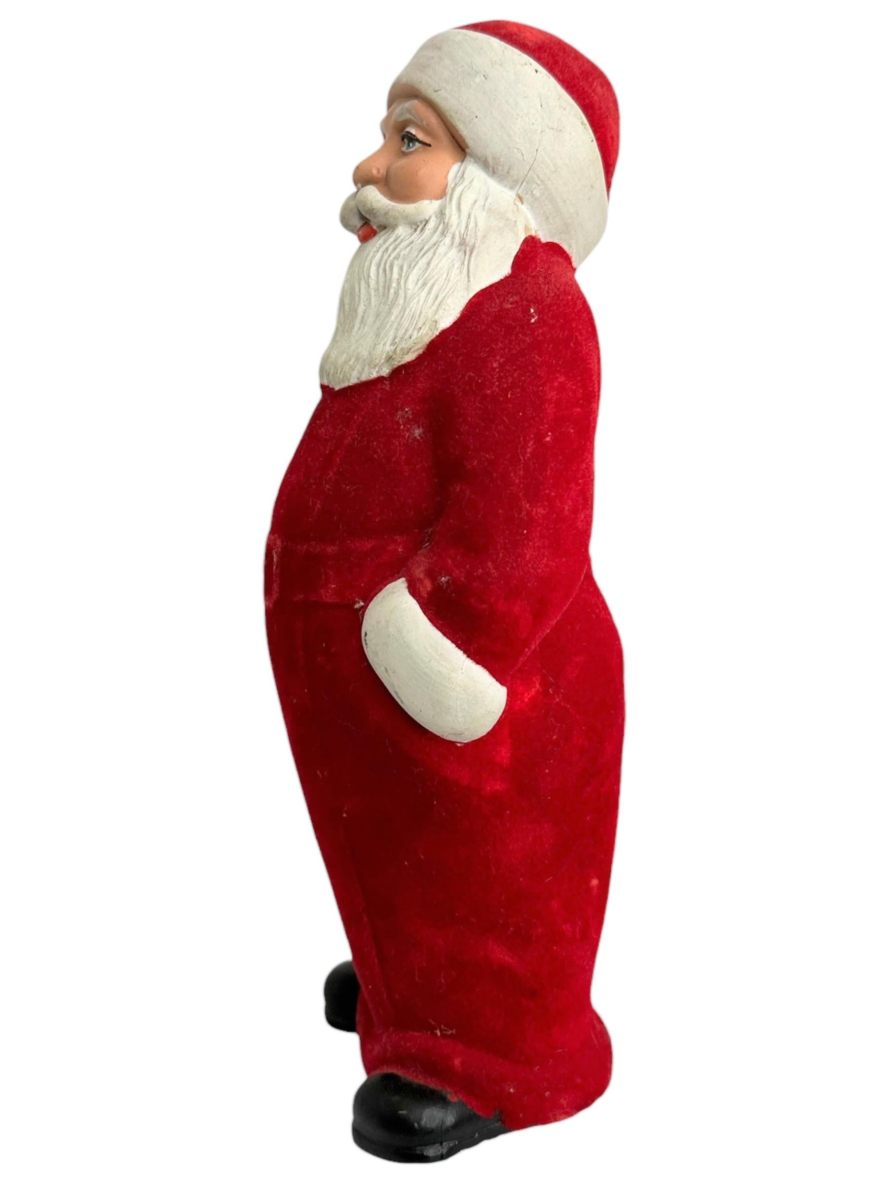 A rare Santa figure with a tree in his hand. Very characterful representation and expressive in its appearance. Velvet dust cover as clothing. Was probably a candy container, but the cap on the bottom is unfortunately missing. One of the larger