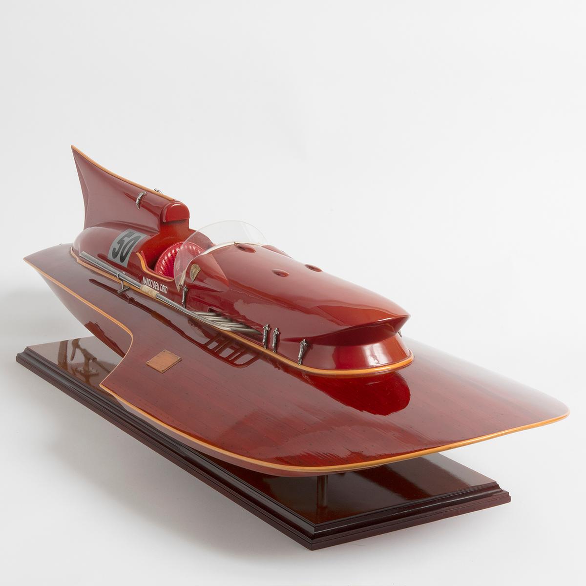This is a beautiful scale model of the Ferrai hydroplane, Arno XI, raced by Nando Dell'Orto. Mounted, and of wood construction, with immense detail, varnished and featuring metal details. The seat is cushioned. The condition of this model is