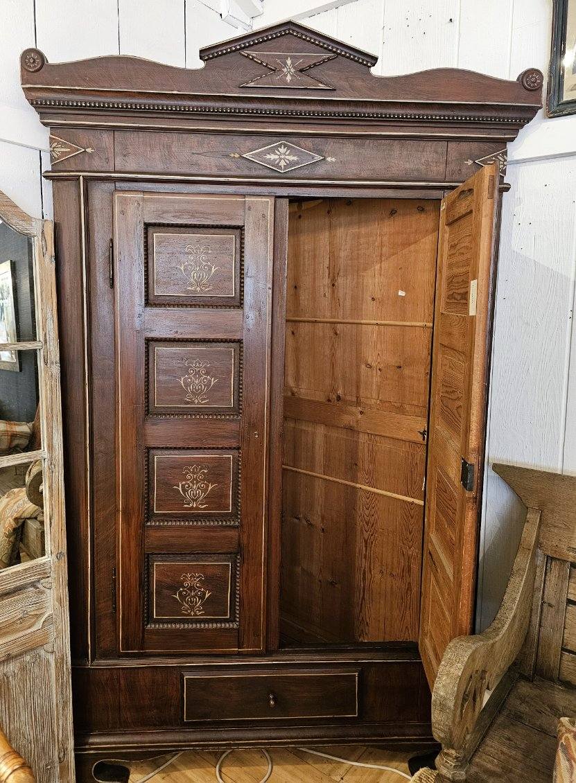 Large handsome dark wood corner cupboard closet having two paneled doors with handpainted interior panels and beading.  Lovely rosettes in the top corner and beautiful cornice.  Interior has large pegs near the open top, perfect for equestrian use. 