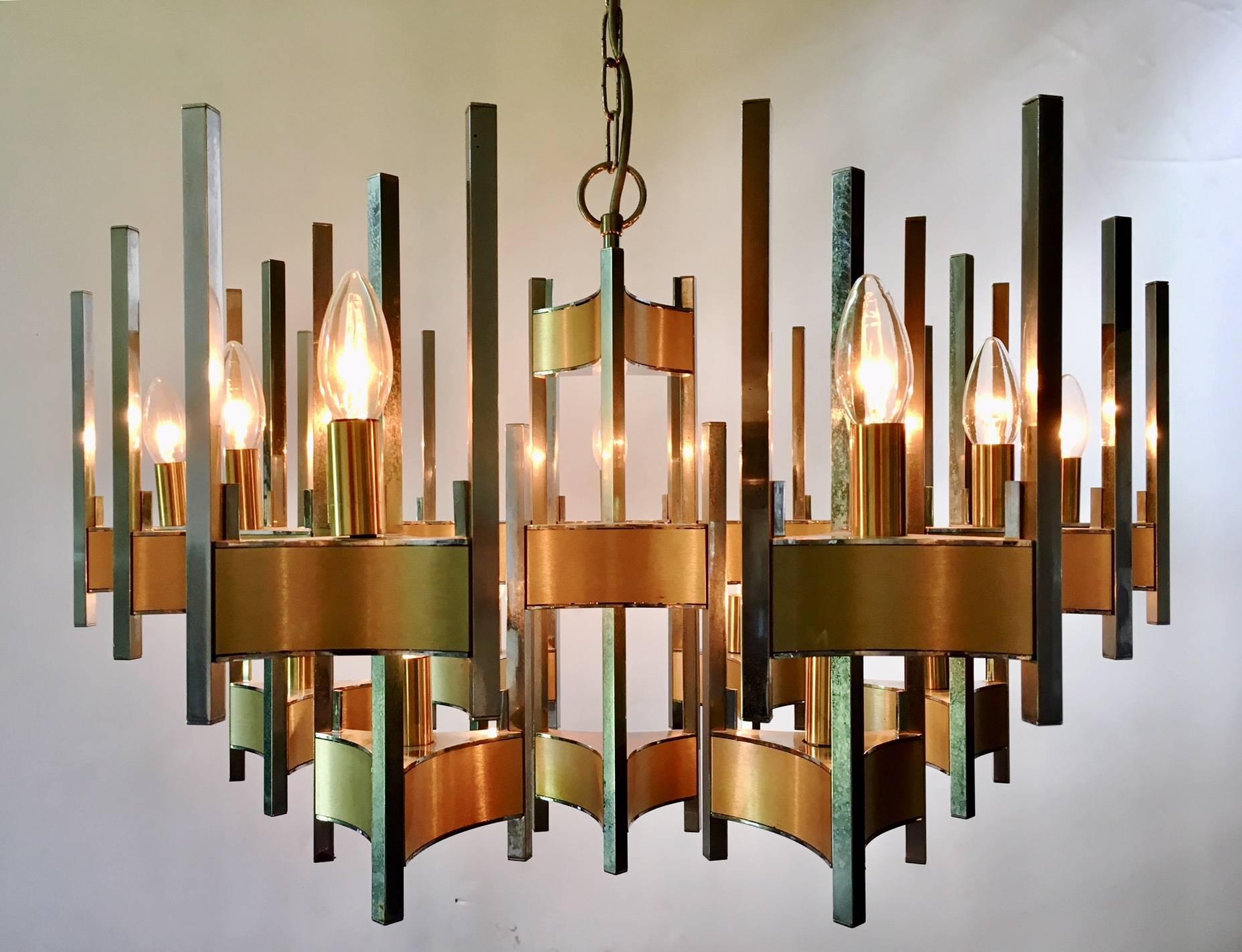 Beautiful fifteen-light design chandelier in brass and brushed chrome. Made in the 1960s or early 1970s by the famous Italian designer Gaetano Sciolari.

The chandelier is in a wonderful condition. 80 cm in width and 45 cm in height. The