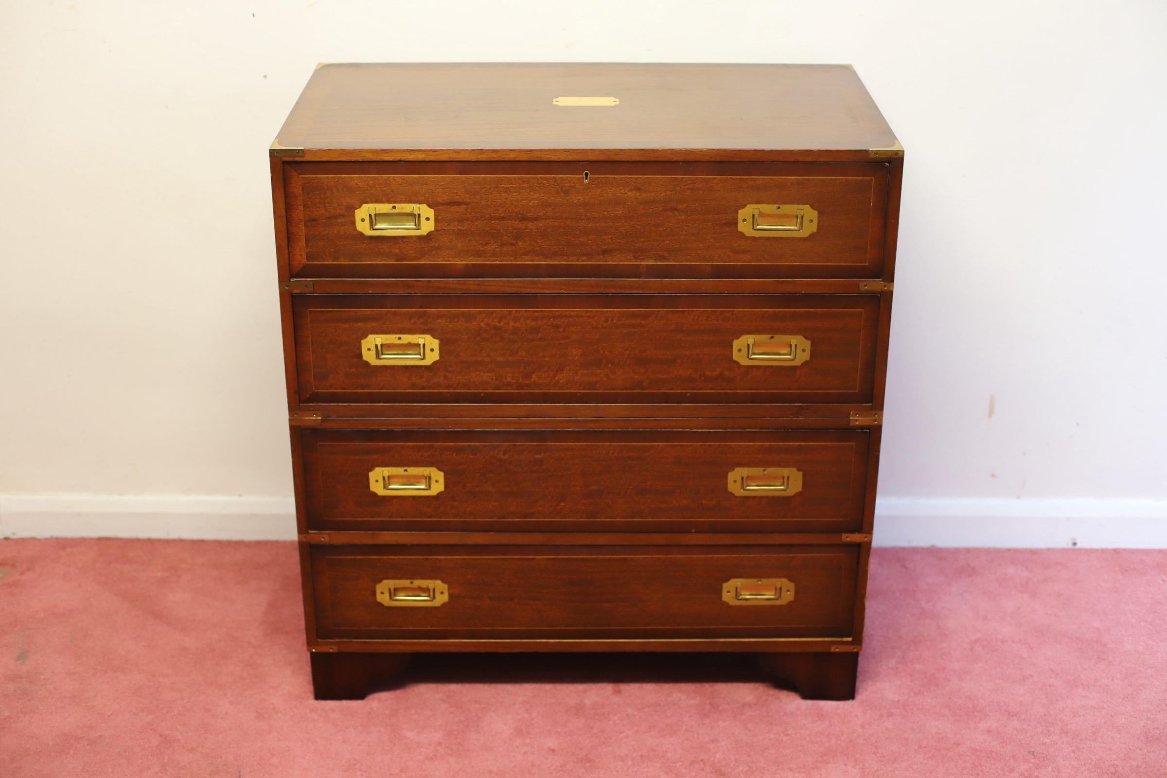 We delight to offer for sale this beautiful two part secretaire campaign chest of drawers circa 1960 , the upper section of the chest having a pull out secretaire drawer enclosing a fully fitted interior with various pigeon holes and three small