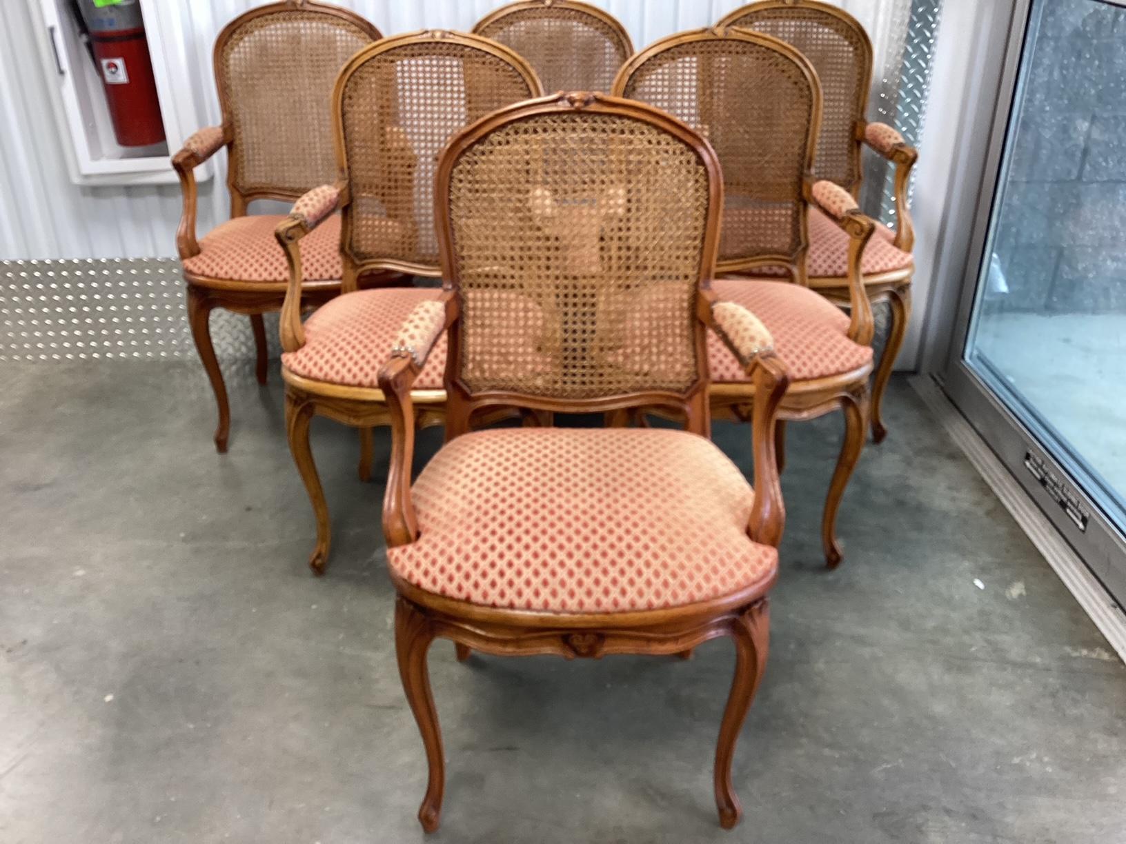 Exceptional set of 6 French walnut and caned back armchairs recently reupholstered in a small diamond pattern raised velvet.  Color is best described as apricot/persimmon. It is subtle and will work well with a number of other colors. Very special