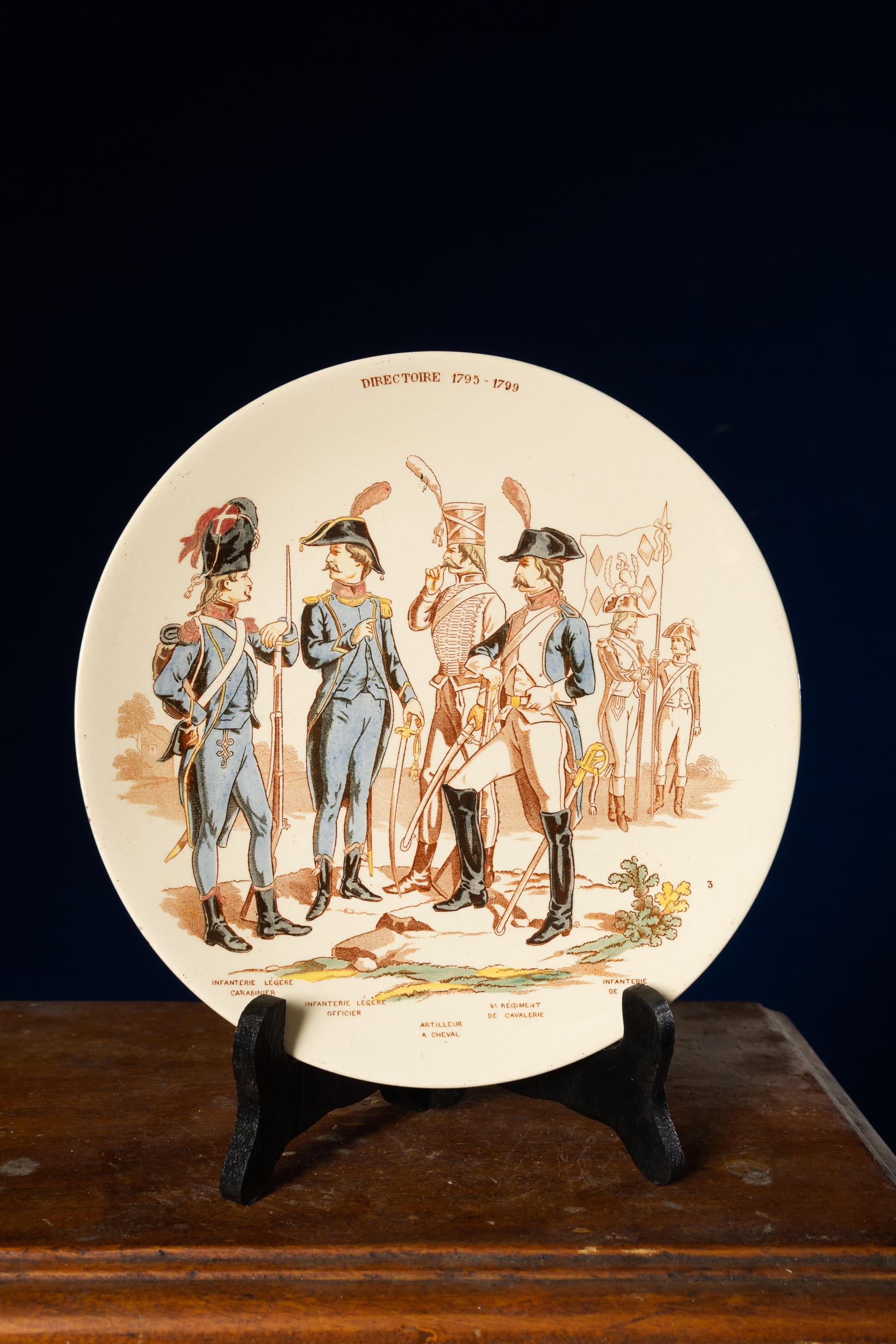 Wonderful set of 7 white faïencerie plates from the late 19th century depicting all types of soldiers and army ranks from 1795-1870. The items are superbly painted with stamped light red designs based on a 