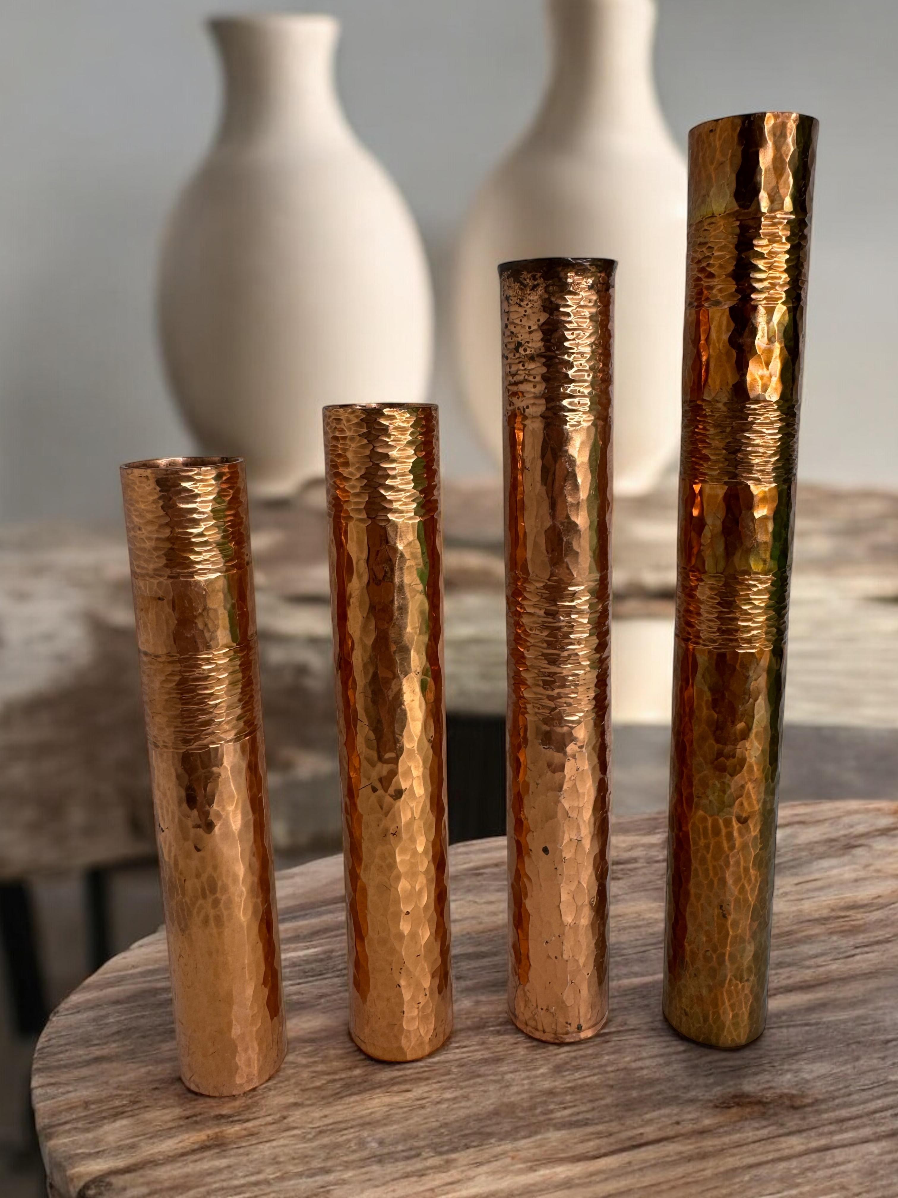 Beautiful set of four flower vases made in Germany, circa 1970s. These are single flower or rose vases. Made of copper, they have some nice patina, but this is old-age. The size given in the dimensions section refers to the largest item seen on the