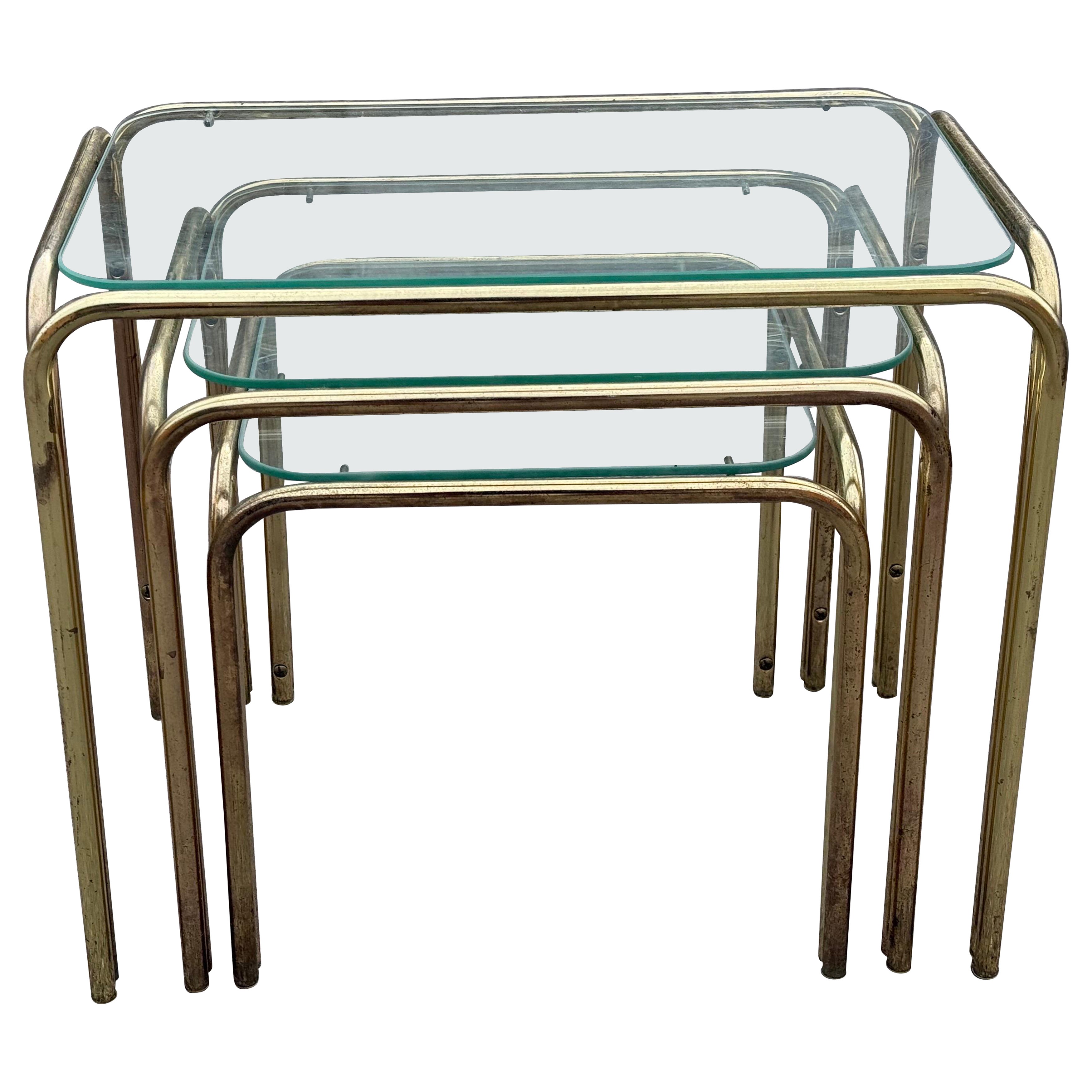 Beautiful set of French 1970's nesting tables in brass and glass For Sale