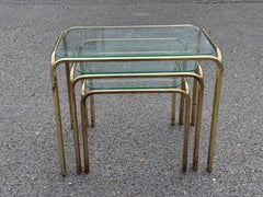 Beautiful set of French 1970's nesting tables in brass and glass