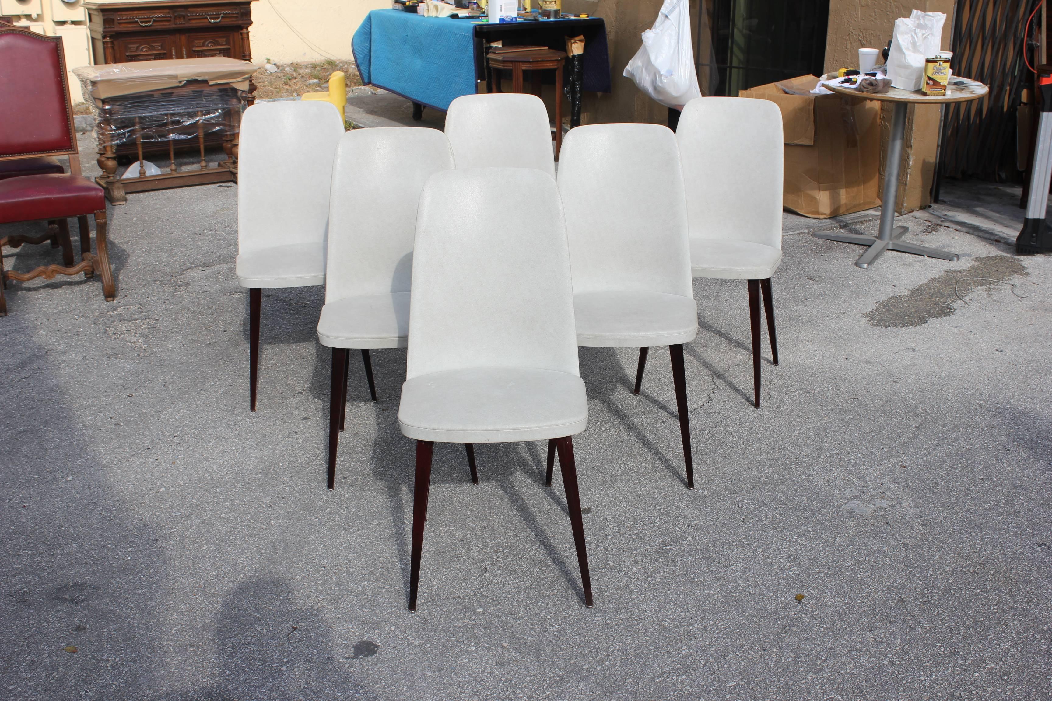 Set of six French Art Deco dining chairs solid mahogany, chair frames are in excellent condition, vinyl all around the top. Reupholstery is vinyl recommended for all six dining chairs, but the color of the vinyl are beautiful, circa 1940s. Beautiful