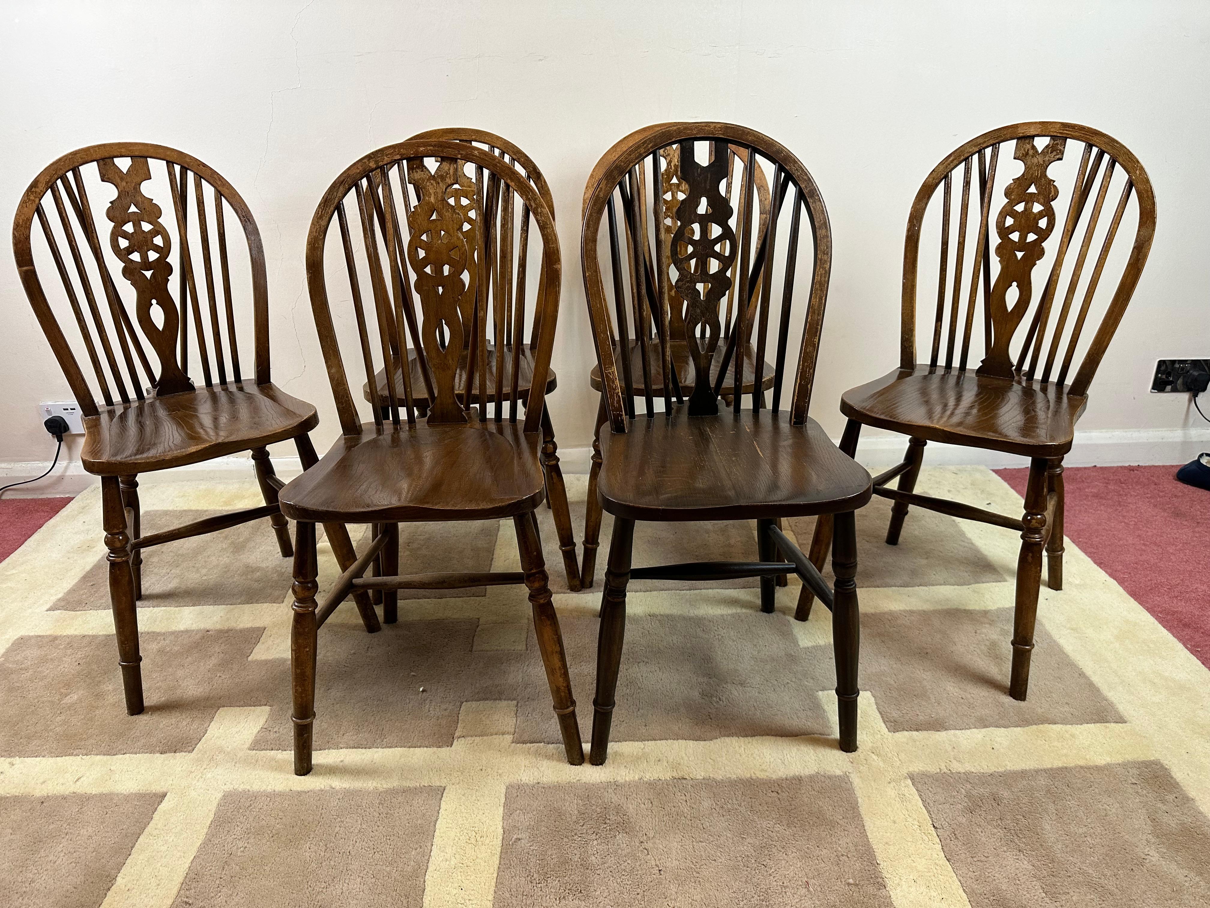 Beautiful set of 6 Vintage English dining chairs Windsor Wheelback  . This set is made in England and is Classic and traditional , Windsor style with the wheelback splat, perfect to blend with any decor , circa 1950. 
Don't hesitate to contact me if
