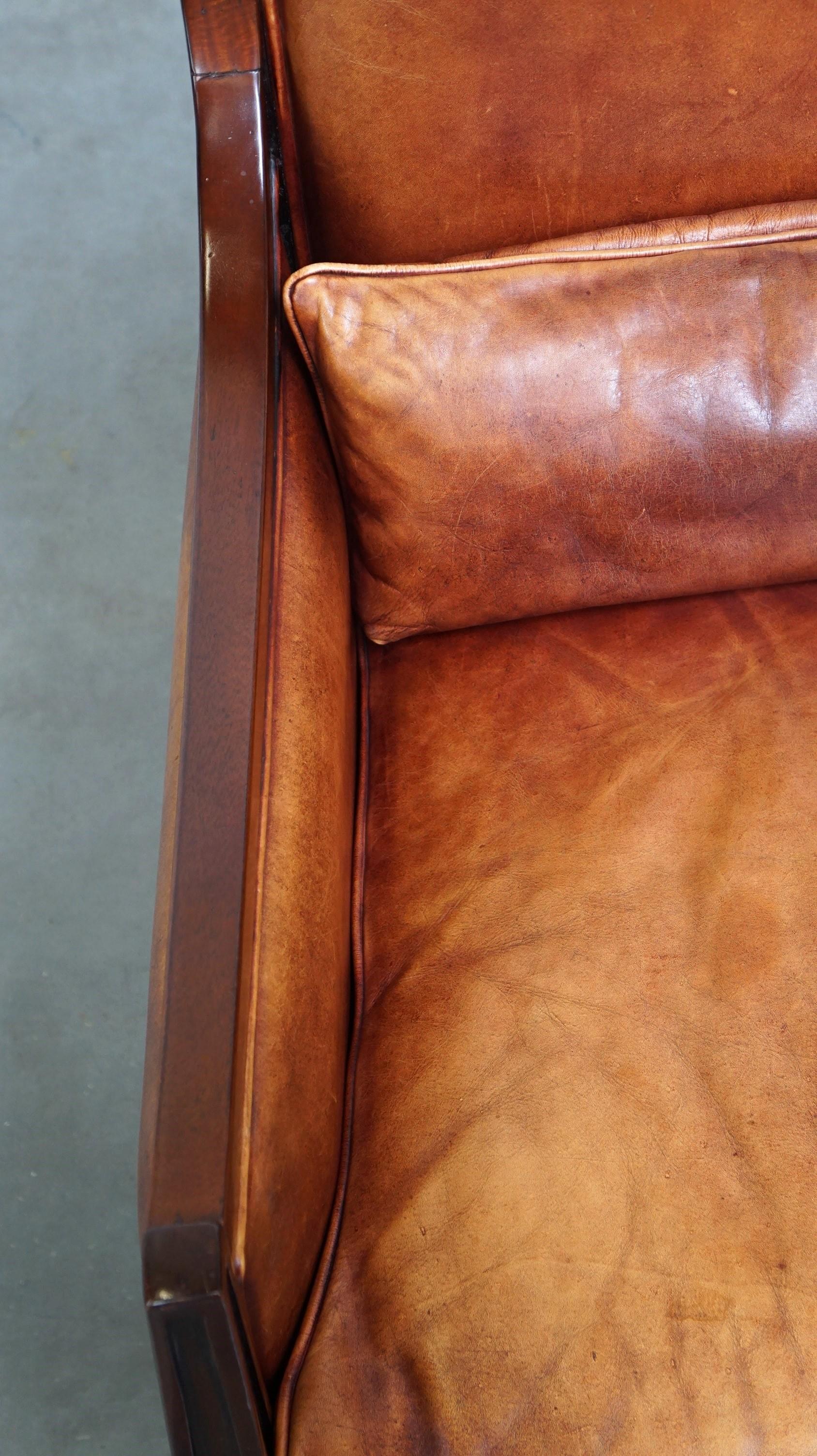 Leather Beautiful sheepskin Art Deco design armchair finished with wood For Sale