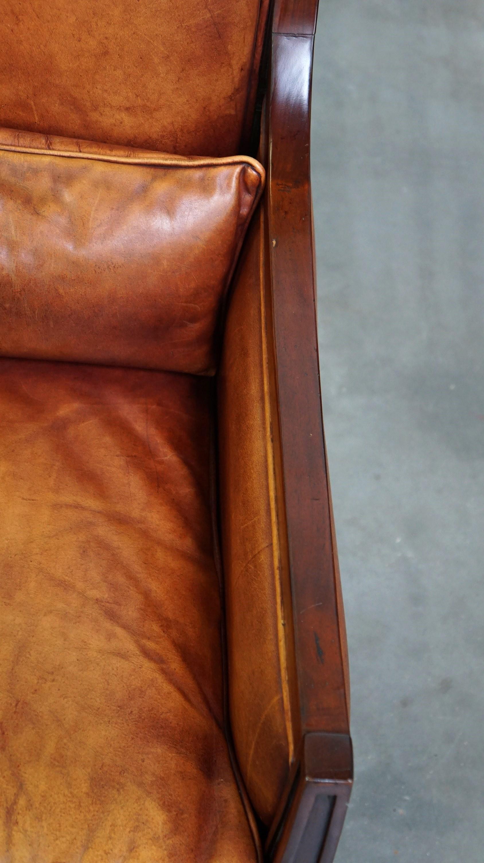 Beautiful sheepskin Art Deco design armchair finished with wood For Sale 1