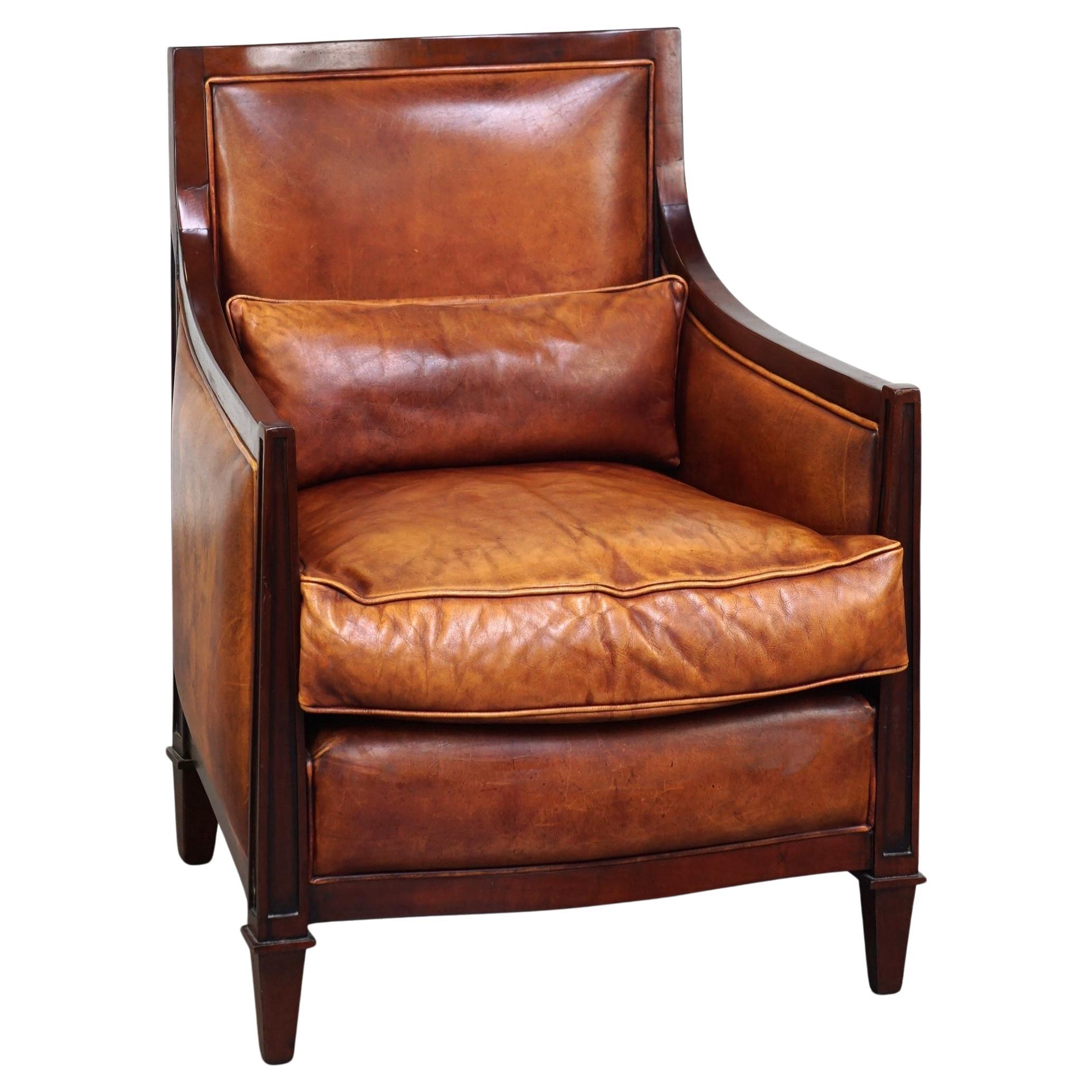 Beautiful sheepskin Art Deco design armchair finished with wood For Sale