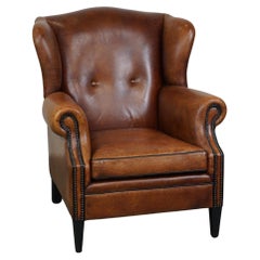 Used Beautiful sheepskin leather wingback armchair finished with nails and black pipi