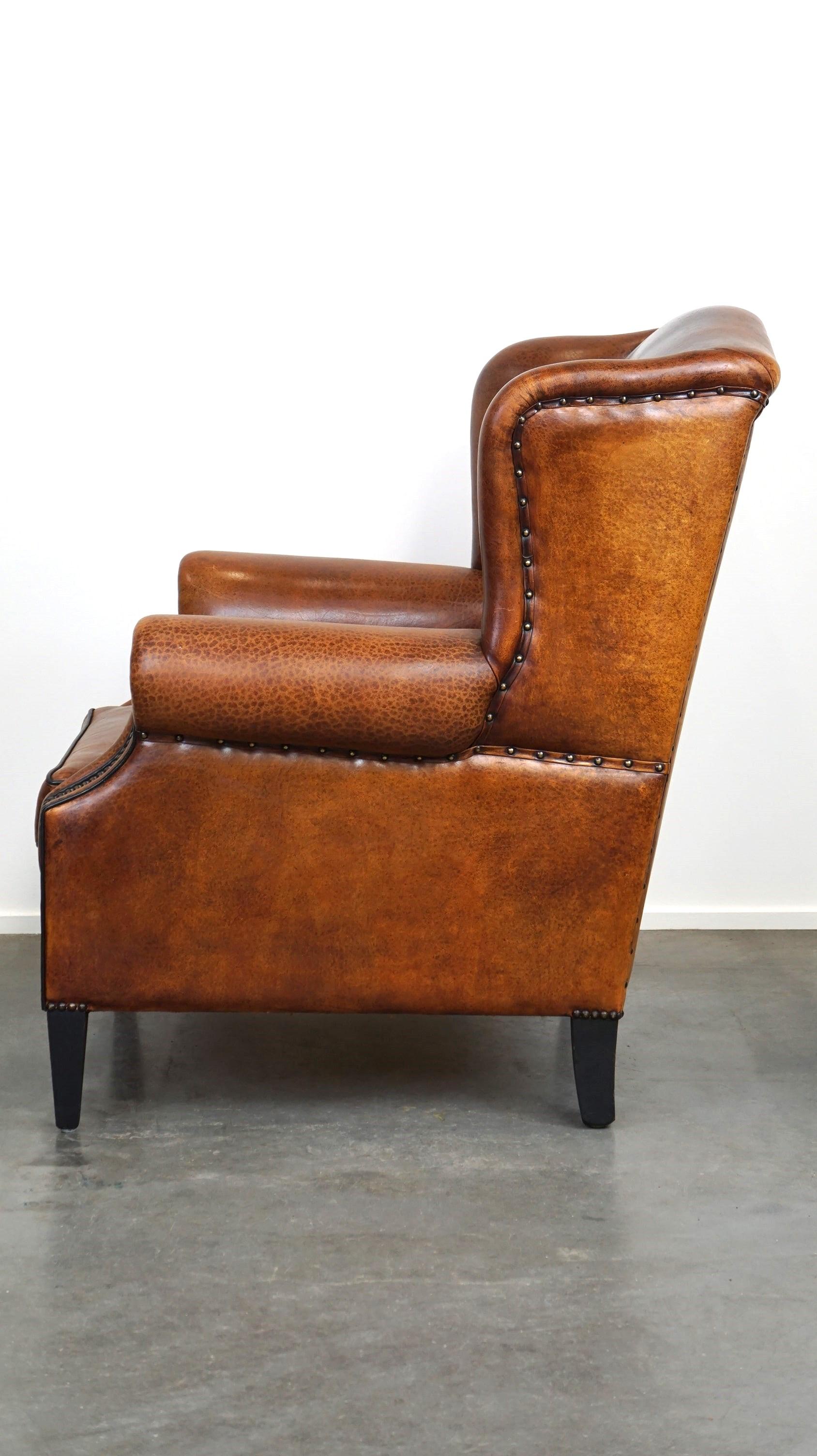Beautiful sheepskin leather wingback armchair, with nails and black piping In Good Condition For Sale In Harderwijk, NL