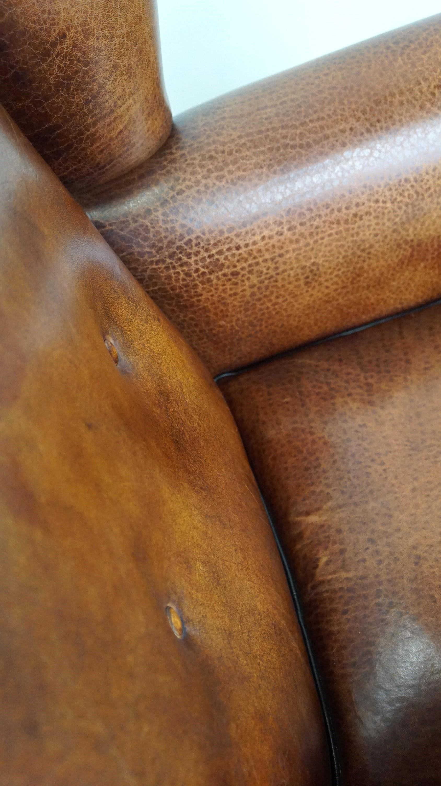Beautiful sheepskin leather wingback armchair, with nails and black piping For Sale 2