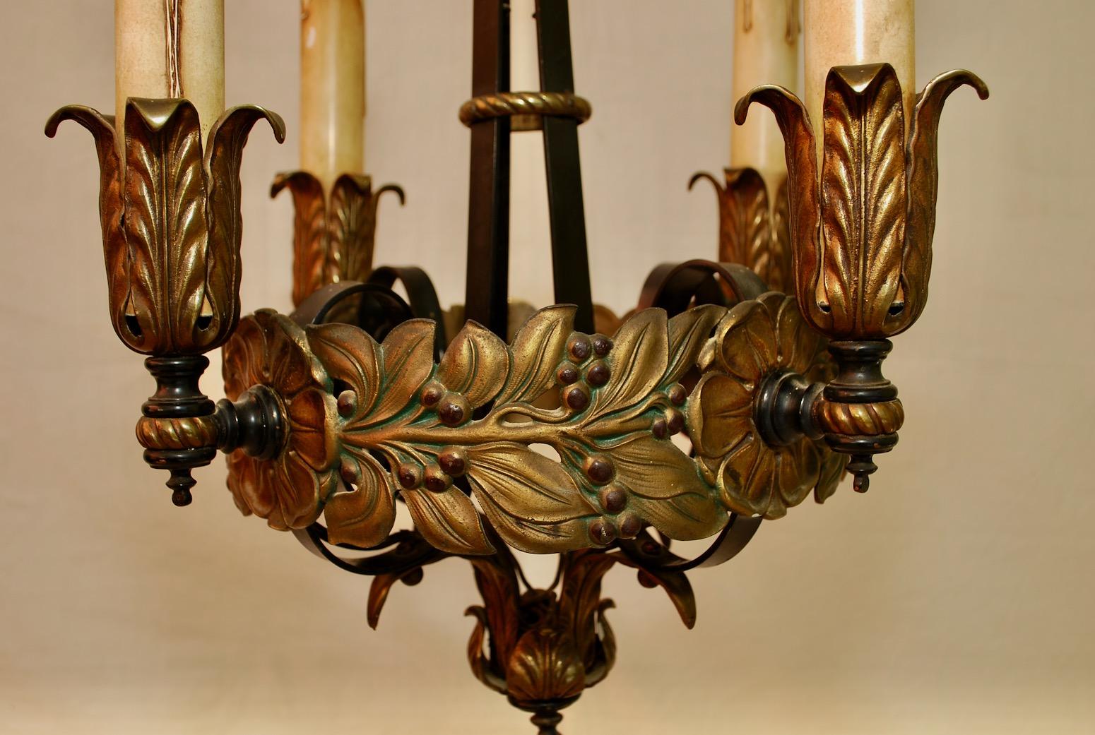 A beautiful and charming 1920s wrought iron and brass chandelier, the patina is much nicer in person.

 