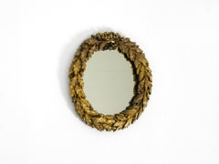 Beautiful small French mid-century wall mirror with an ornate brass frame