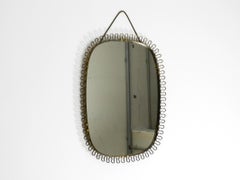 Beautiful small heavy Mid Century metal wall mirror in bow design in gold colour