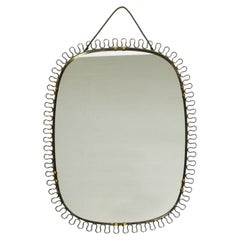 Beautiful small heavy Mid Century metal wall mirror in bow design in gold colour