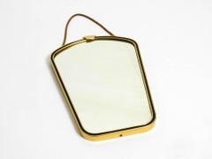 Beautiful small mid-century brass wall mirror with braided hanging strap