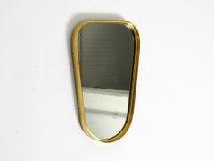 Beautiful small solid Mid Century brass wall mirror by Münchener Zierspiegel