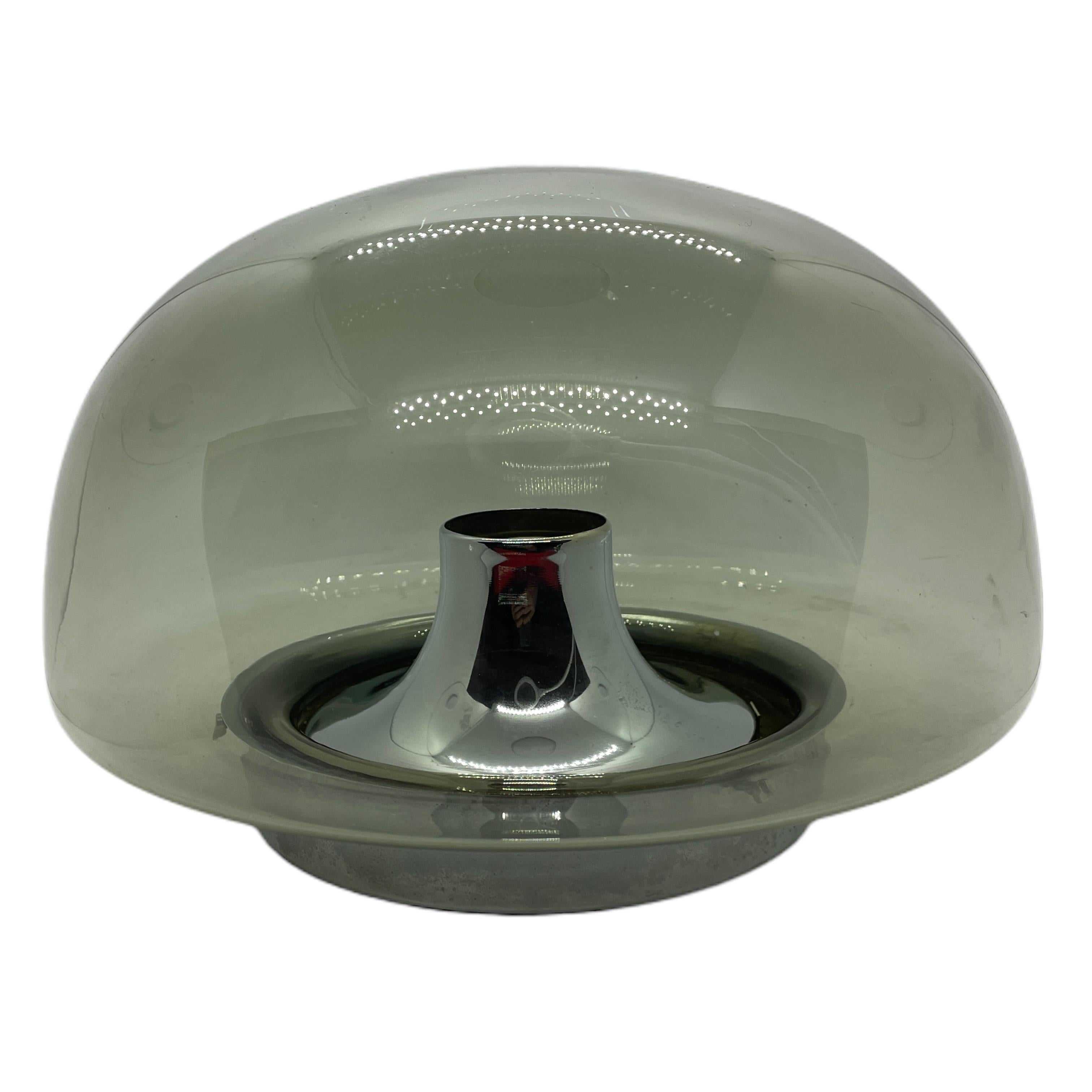 A beautiful flush mount by German manufacturer Glashuette Limburg. The glass element is supported by a chrome base plate with a one light source. Beautiful grey smoked glass on a metal fixture. The Fixture requires one European E27 / 110 Volt Edison