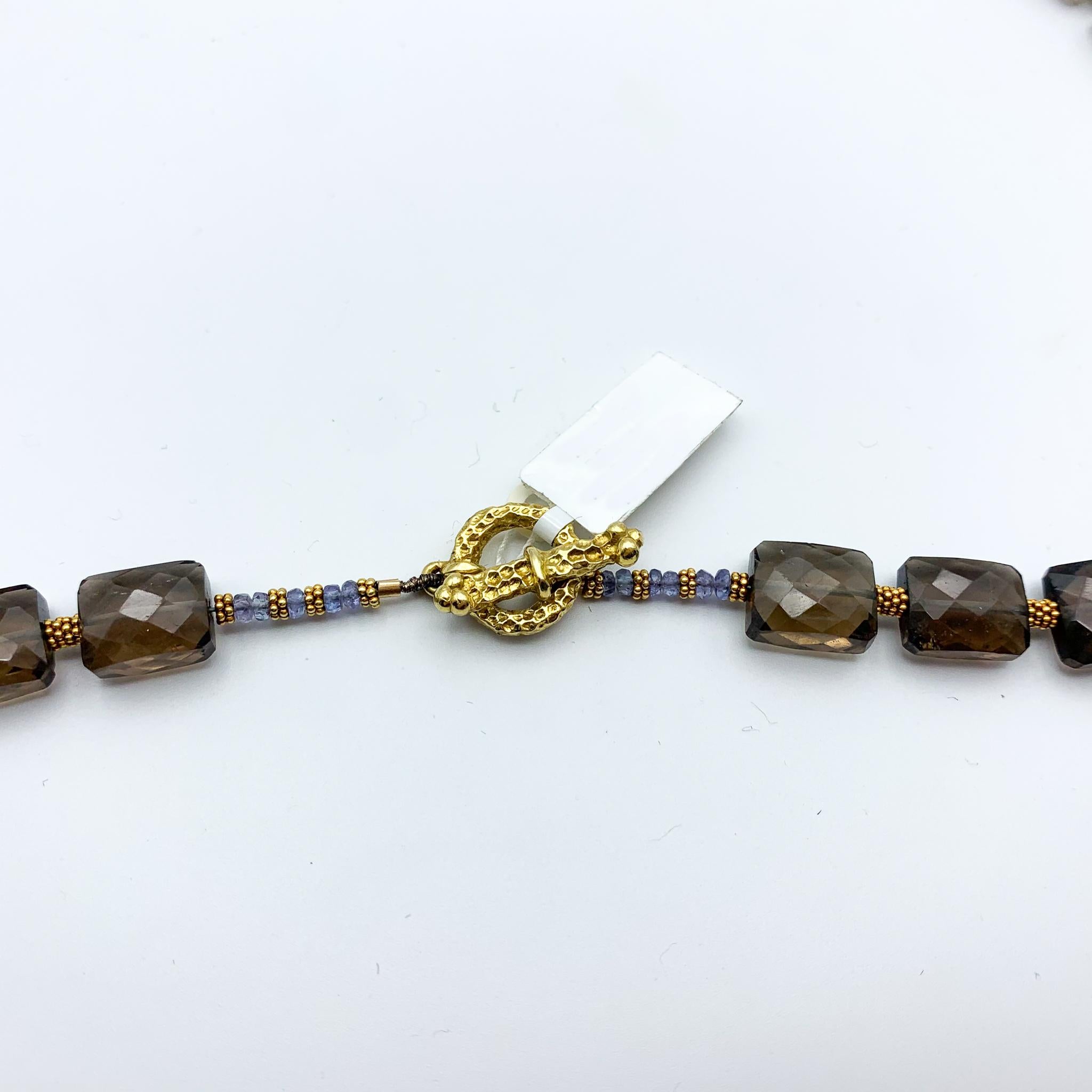 Fine crafted Smokey Quartz, Sapphires, and Gold beads 
Bar & Ring Clasp 
Approximately 21 inches in length/around. 