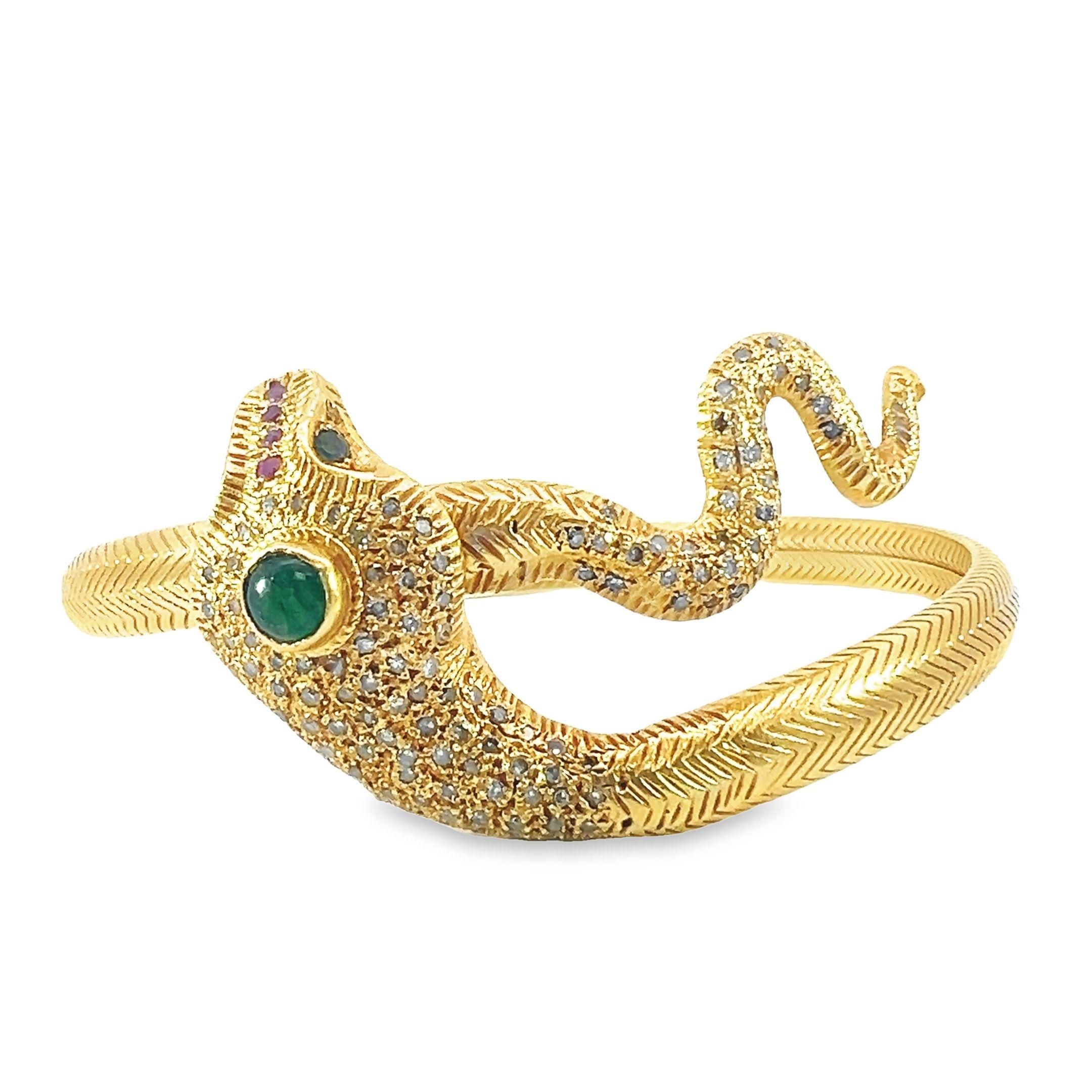 A beautiful 18-karat solid gold serpent bangle made with natural 2.30-carat diamonds, 0.45-carat-emeralds and 0.04-carat ruby.  It's eyes set with mesmerizing emerald stones to captivate any onlooker. 
